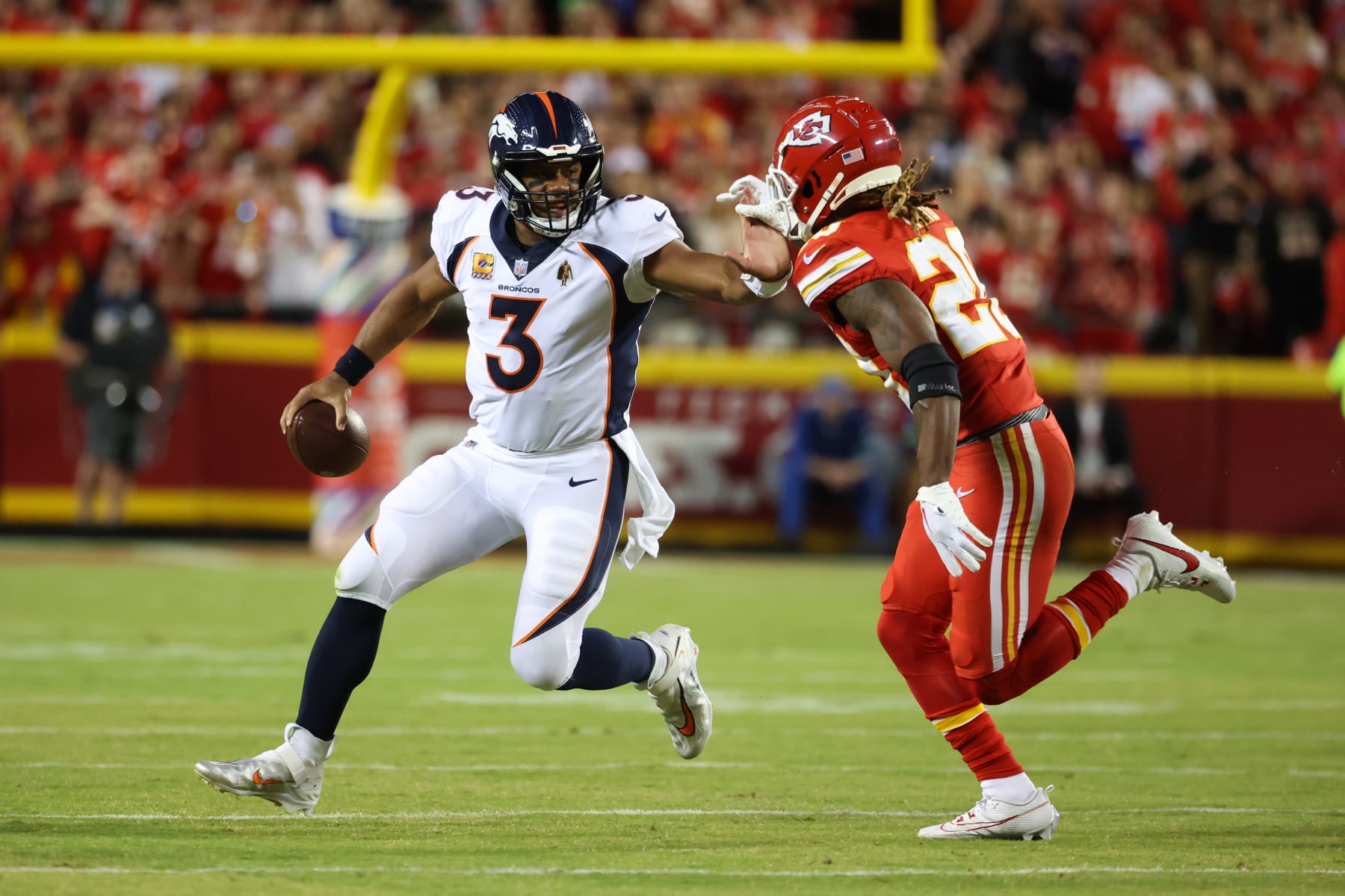 KANSAS CITY, MO - OCTOBER 12: Denver Broncos quarterback Russell Wilson (3) can't escape Kansas City Chiefs safety Justin Reid (20) on a fourth down play in the first quarter of an AFC West matchup between the Denver Broncos and Kansas City Chiefs on Oct 12, 2023 at GEHA Field at Arrowhead Stadium in Kansas City, MO.  (Photo by Scott Winters/Icon Sportswire via Getty Images)