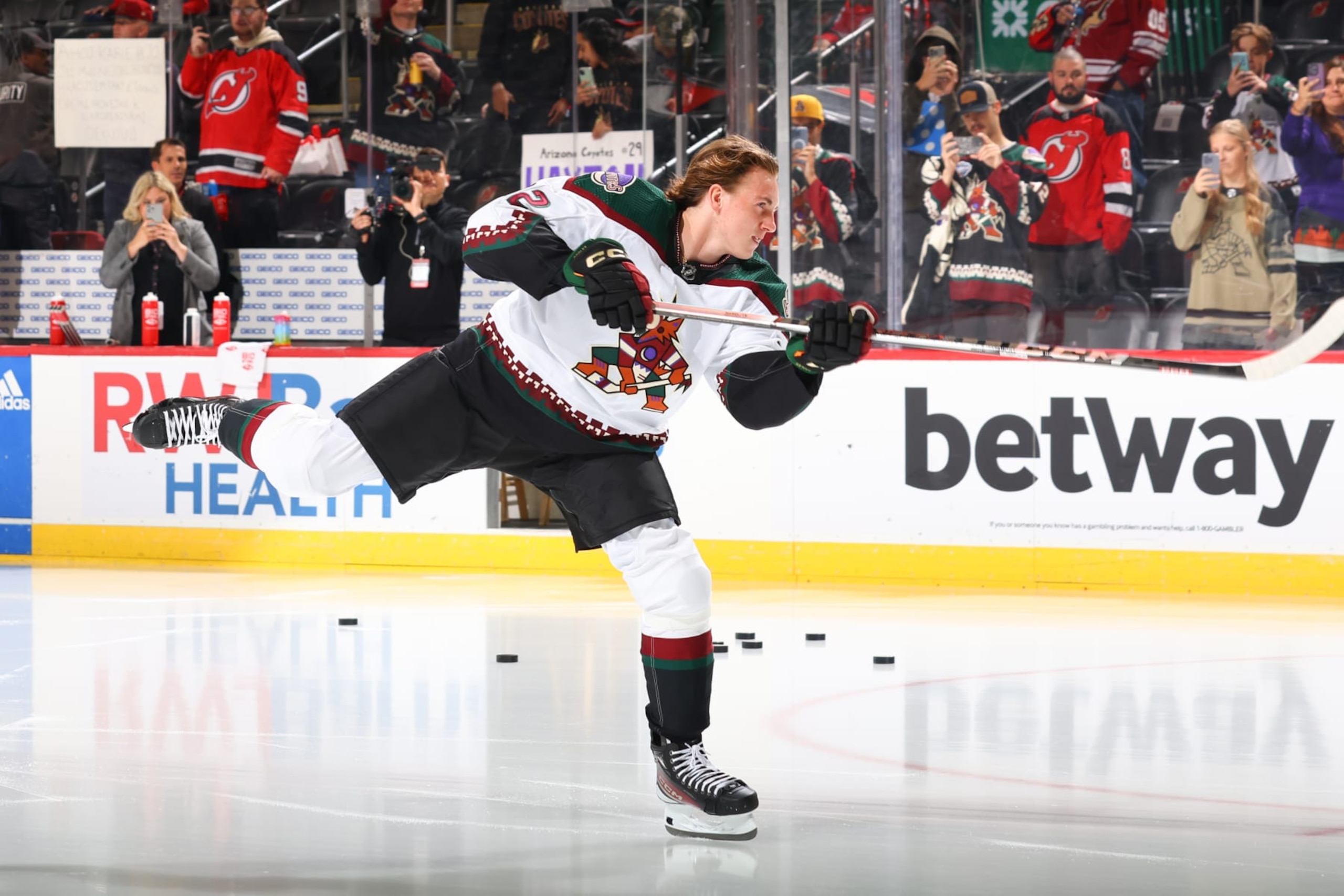 NEWARK, NJ - OCTOBER 13: Logan Cooley #92 of the Arizona Coyotes skates his rookie lap prior to the game against the New Jersey Devils at the Prudential Center on October 13 in Newark, New Jersey.  (Photo by Rich Graessle/NHLI via Getty Images)