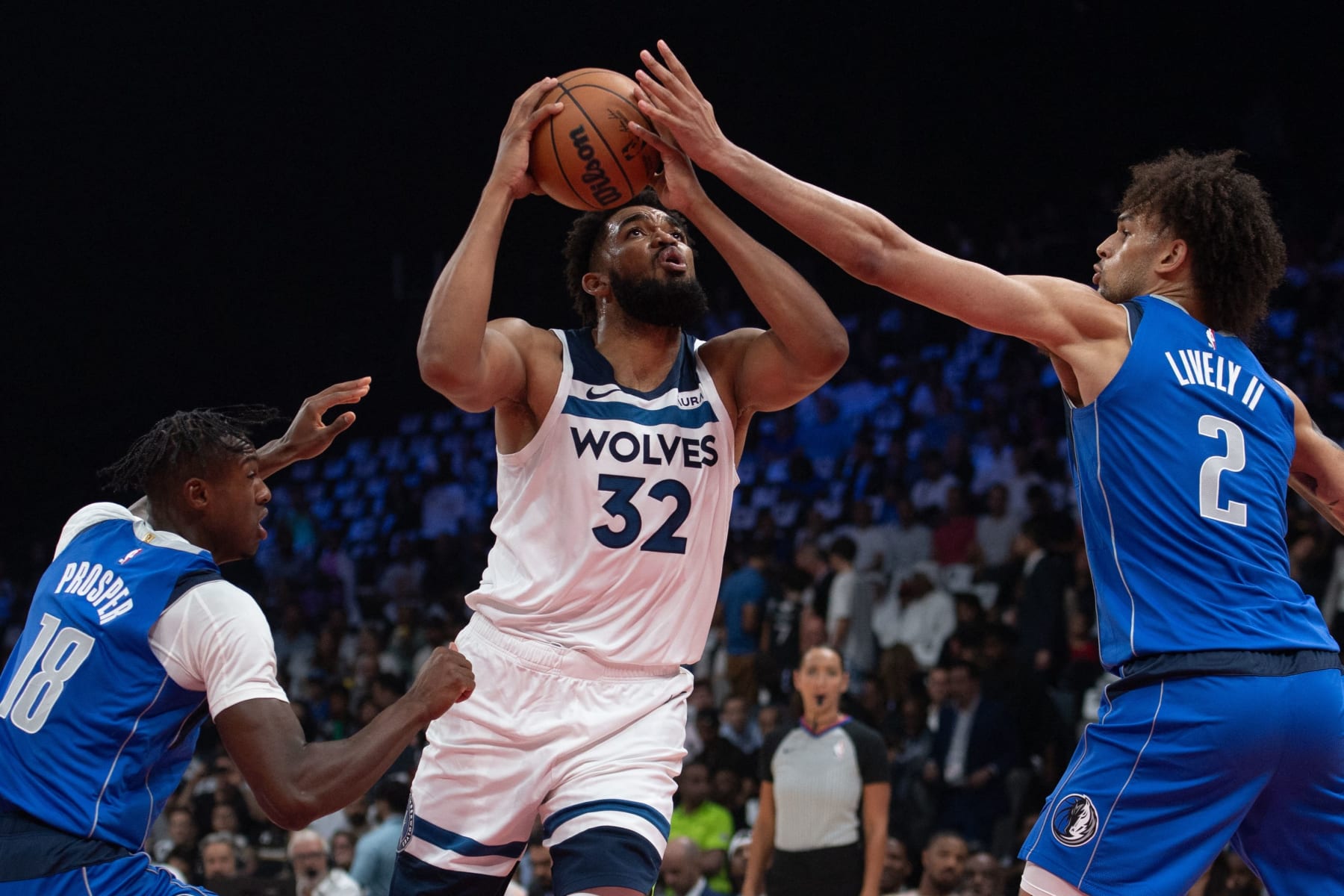 Minnesota Timberwolves' forward Karl-Anthony Towns #32 attempts a shot as he is marked by Dallas Mavericks' center Dereck Lively #2 during the NBA Preseason game Between the Dallas Mavericks and the Minnesota Timberwolves at the Etihad Arena in Abu Dhabi on October 5, 2023. (Photo by Ryan LIM / AFP) (Photo by RYAN LIM/AFP via Getty Images)