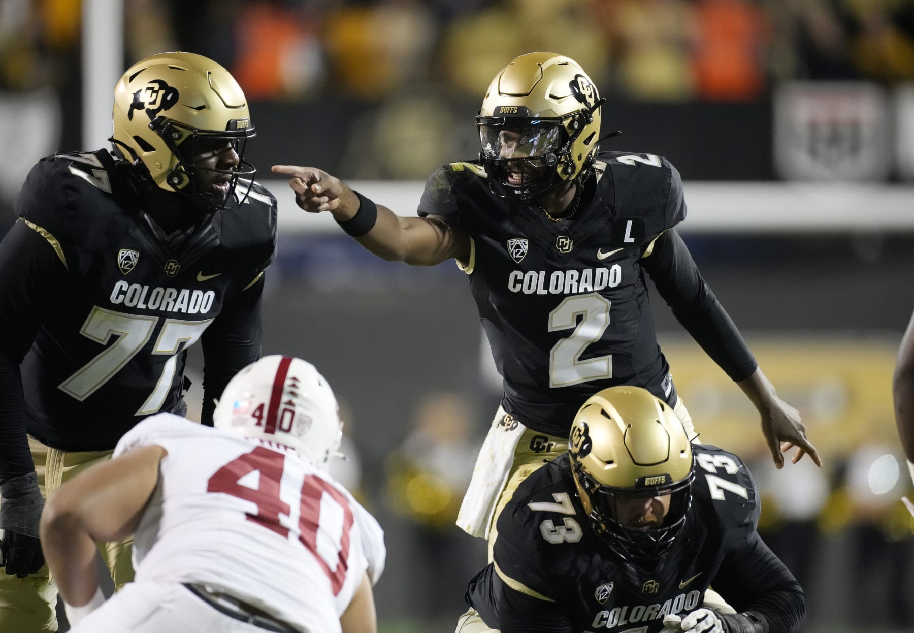 Colorado quarterback Shedeur Sanders directs teammates during the first half of an NCAA college football game against Stanford on Friday, Oct. 13, 2023, in Boulder, Colo. (AP Photo/David Zalubowski)