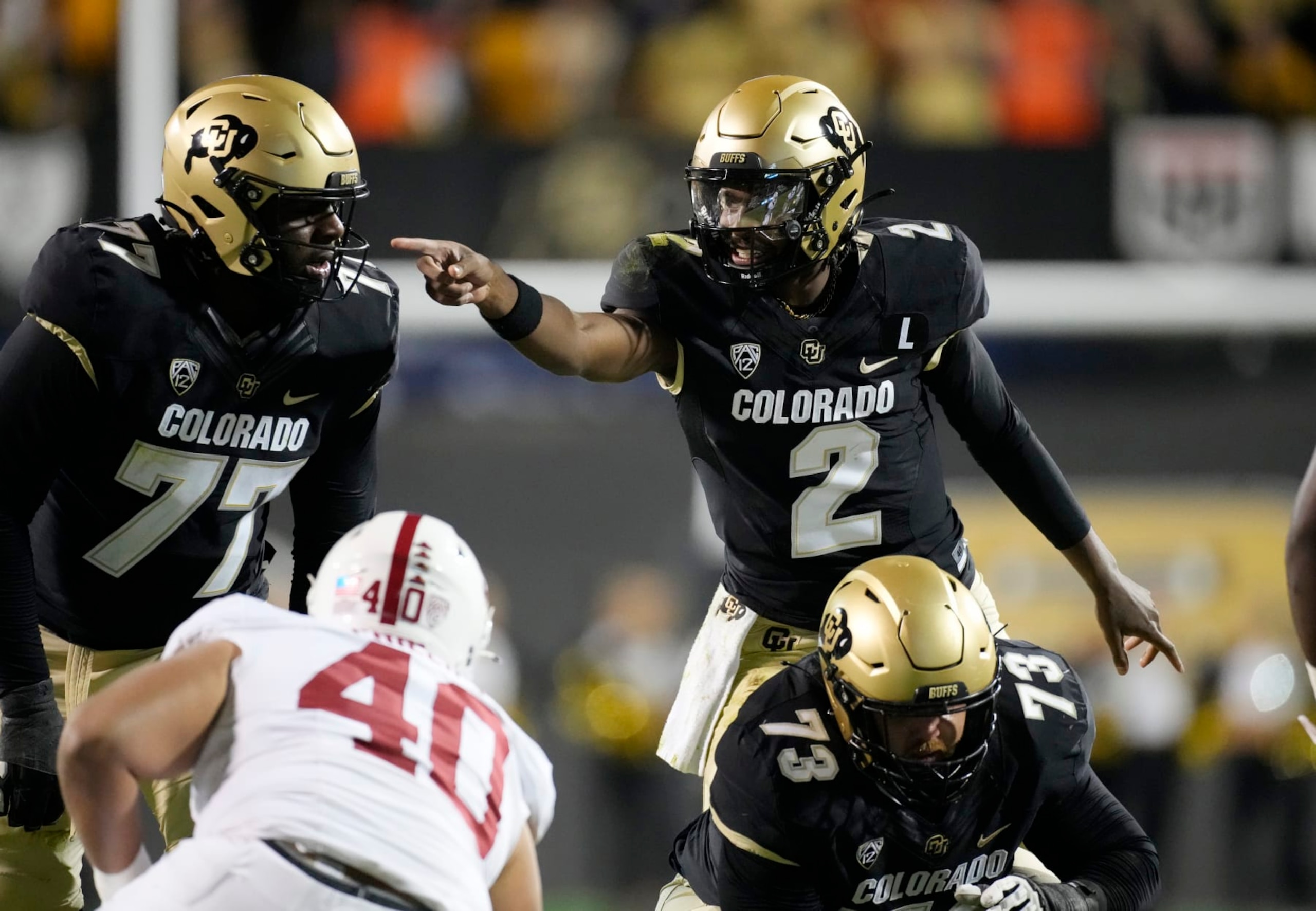 Colorado quarterback Shedeur Sanders directs teammates during the first half of an NCAA college football game against Stanford on Friday, Oct. 13, 2023, in Boulder, Colo. (AP Photo/David Zalubowski)