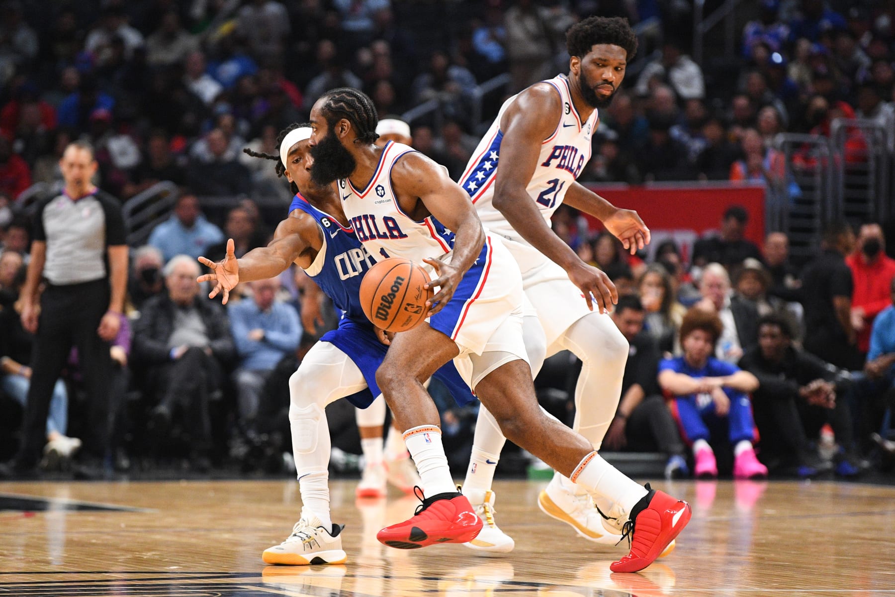 LOS ANGELES, CA - JANUARY 17: Philadelphia 76ers Guard James Harden (1) guarded by Los Angeles Clippers Guard Terance Mann (14) as Philadelphia 76ers Center Joel Embiid (21) sets a screen during a NBA game between the Philadelphia 76ers and the Los Angeles Clippers on January 17, 2023 at Crypto.com Arena in Los Angeles, CA. (Photo by Brian Rothmuller/Icon Sportswire via Getty Images)