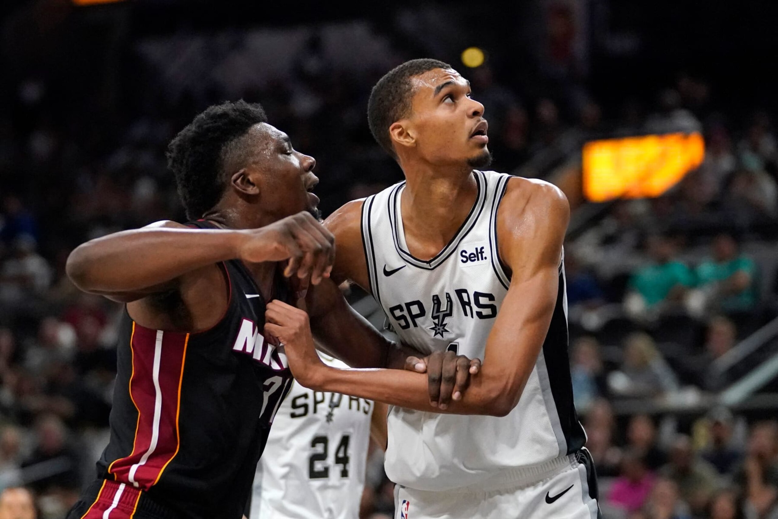 San Antonio Spurs' French forward #01 Victor Wembanyama (R) is guarded by Miami Heat' Thomas Bryant  during the NBA preseason game between the San Antonio Spurs and Miami Heat at the AT&T Center in San Antonio, Texas, on October 13, 2023. (Photo by TIMOTHY A. CLARY / AFP) (Photo by TIMOTHY A. CLARY/AFP via Getty Images)