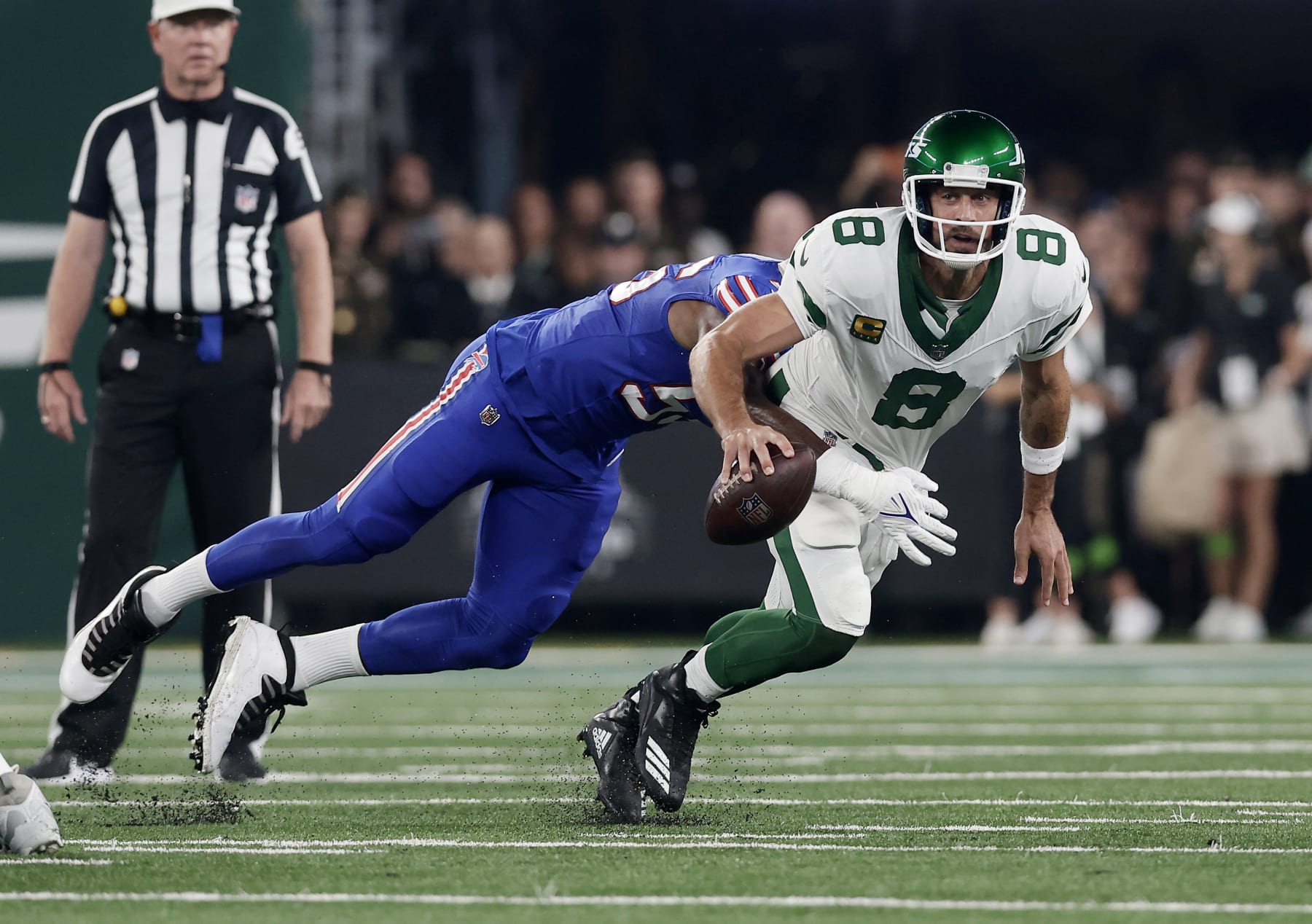 EAST RUTHERFORD, NEW JERSEY - SEPTEMBER 11: (NEW YORK DAILIES OUT)  Aaron Rodgers #8 of the New York Jets is sacked during the first quarter by Leonard Floyd #56 of the Buffalo Bills at MetLife Stadium on September 11, 2023 in East Rutherford, New Jersey. The Jets defeated the Bills 22-16 in overtime. (Photo by Jim McIsaac/Getty Images)