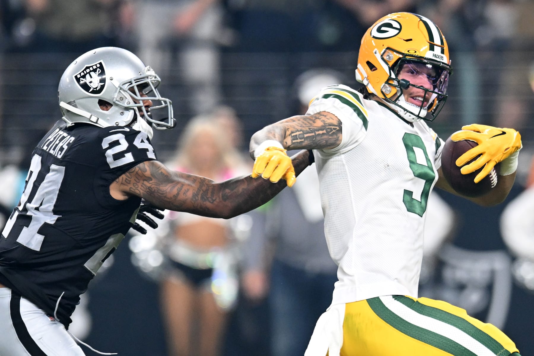 LAS VEGAS, NEVADA - OCTOBER 09: Christian Watson #9 of the Green Bay Packers runs with the ball against Marcus Peters #24 of the Las Vegas Raiders during the third quarter at Allegiant Stadium on October 09, 2023 in Las Vegas, Nevada. (Photo by Candice Ward/Getty Images)