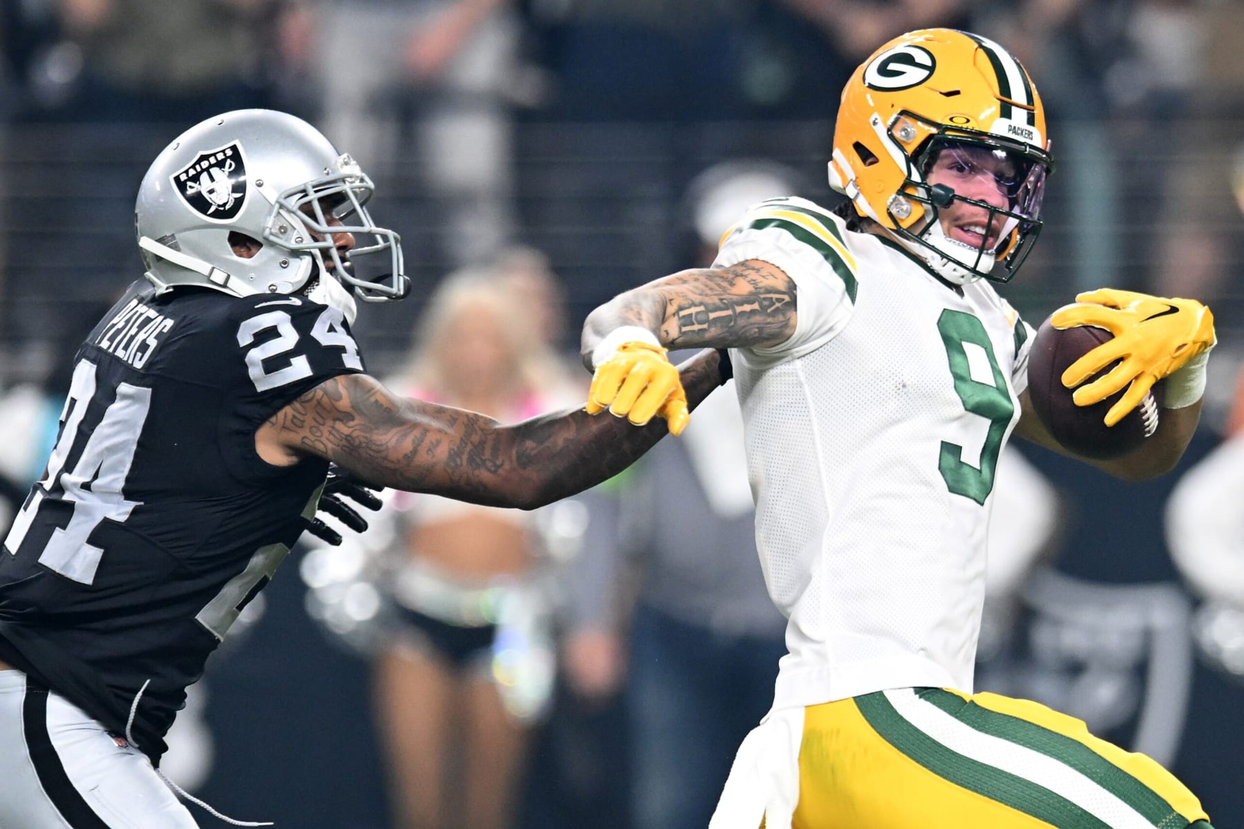 LAS VEGAS, NEVADA - OCTOBER 09: Christian Watson #9 of the Green Bay Packers runs with the ball against Marcus Peters #24 of the Las Vegas Raiders during the third quarter at Allegiant Stadium on October 09, 2023 in Las Vegas, Nevada. (Photo by Candice Ward/Getty Images)