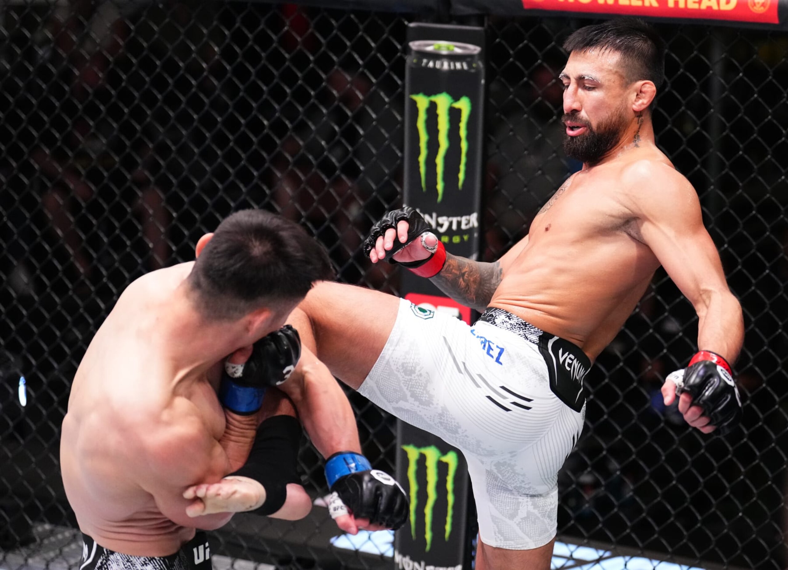 Chris Gutierrez throws a knee at Alatengheili.