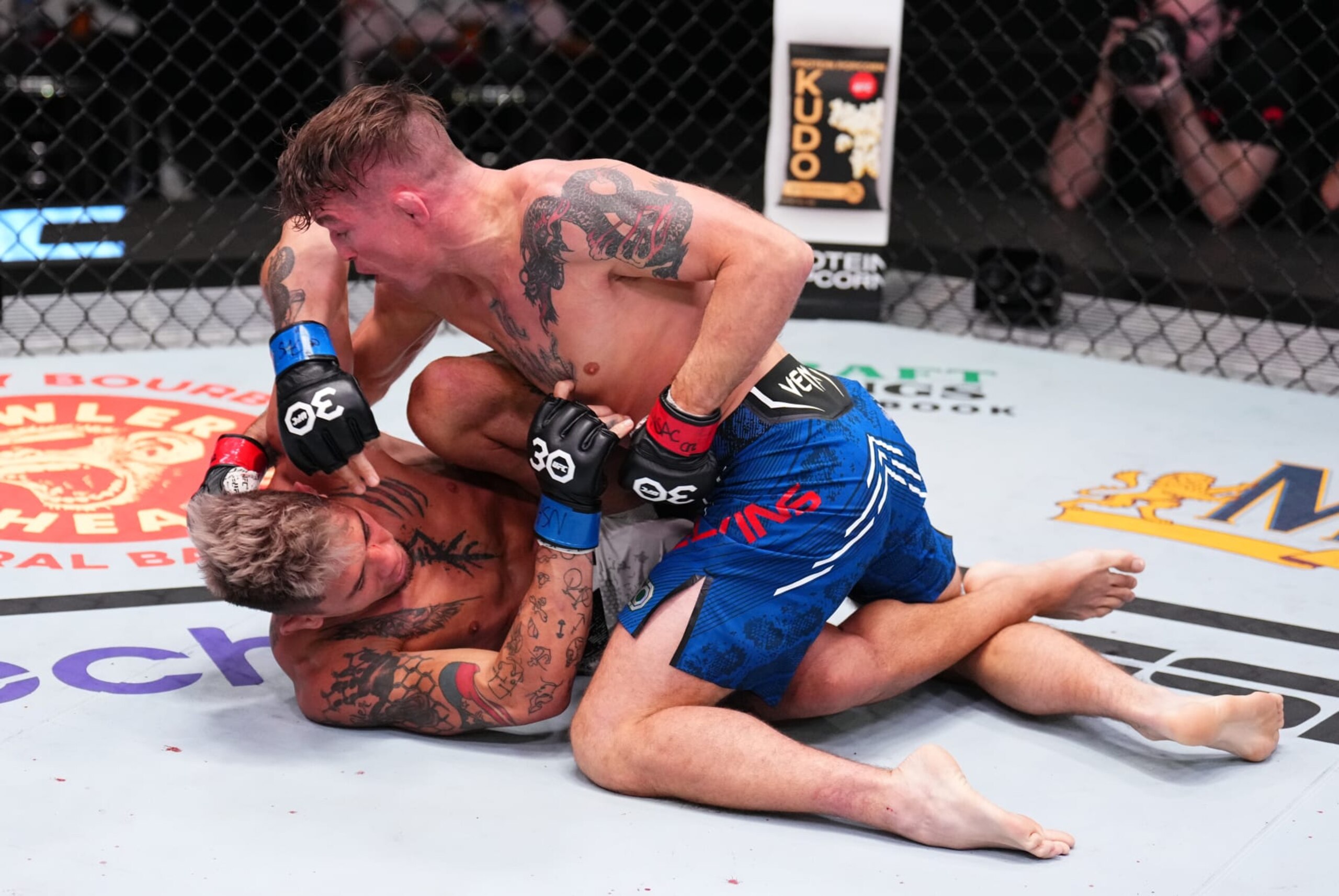LAS VEGAS, NEVADA - OCTOBER 14: (R-L) Darren Elkins punches TJ Brown in a featherweight fight during the UFC Fight Night event at UFC APEX on October 14, 2023 in Las Vegas, Nevada. (Photo by Chris Unger/Zuffa LLC via Getty Images)