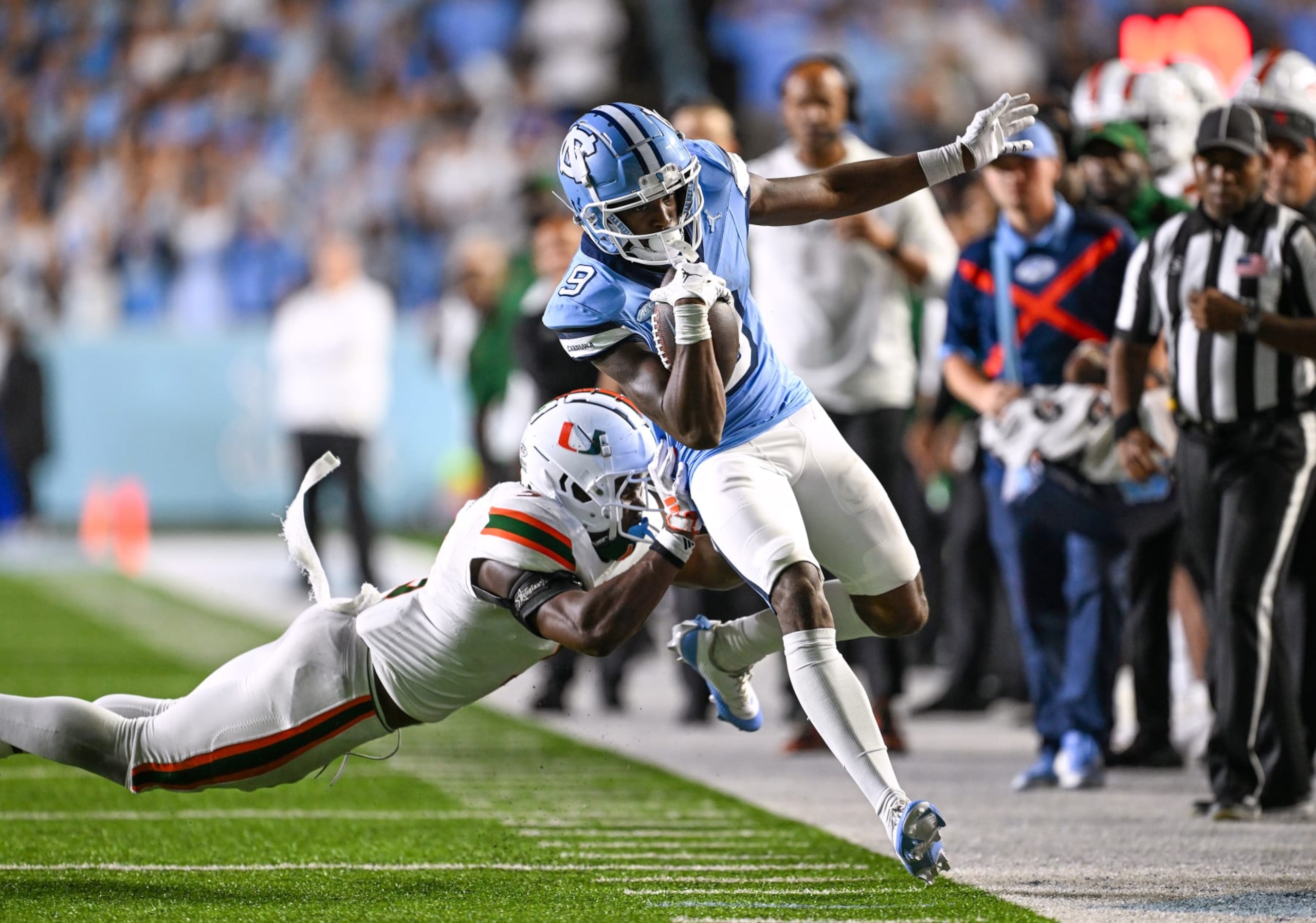 CHAPEL HILL, NORTH CAROLINA - OCTOBER 14: Kamren Kinchens #5 of the Miami Hurricanes attempts to drive Devontez Walker #9 of the North Carolina Tar Heels out of bounds during the second half of their game at Kenan Memorial Stadium on October 14, 2023 in Chapel Hill, North Carolina. The Tar Heels won 41-31. (Photo by Grant Halverson/Getty Images)