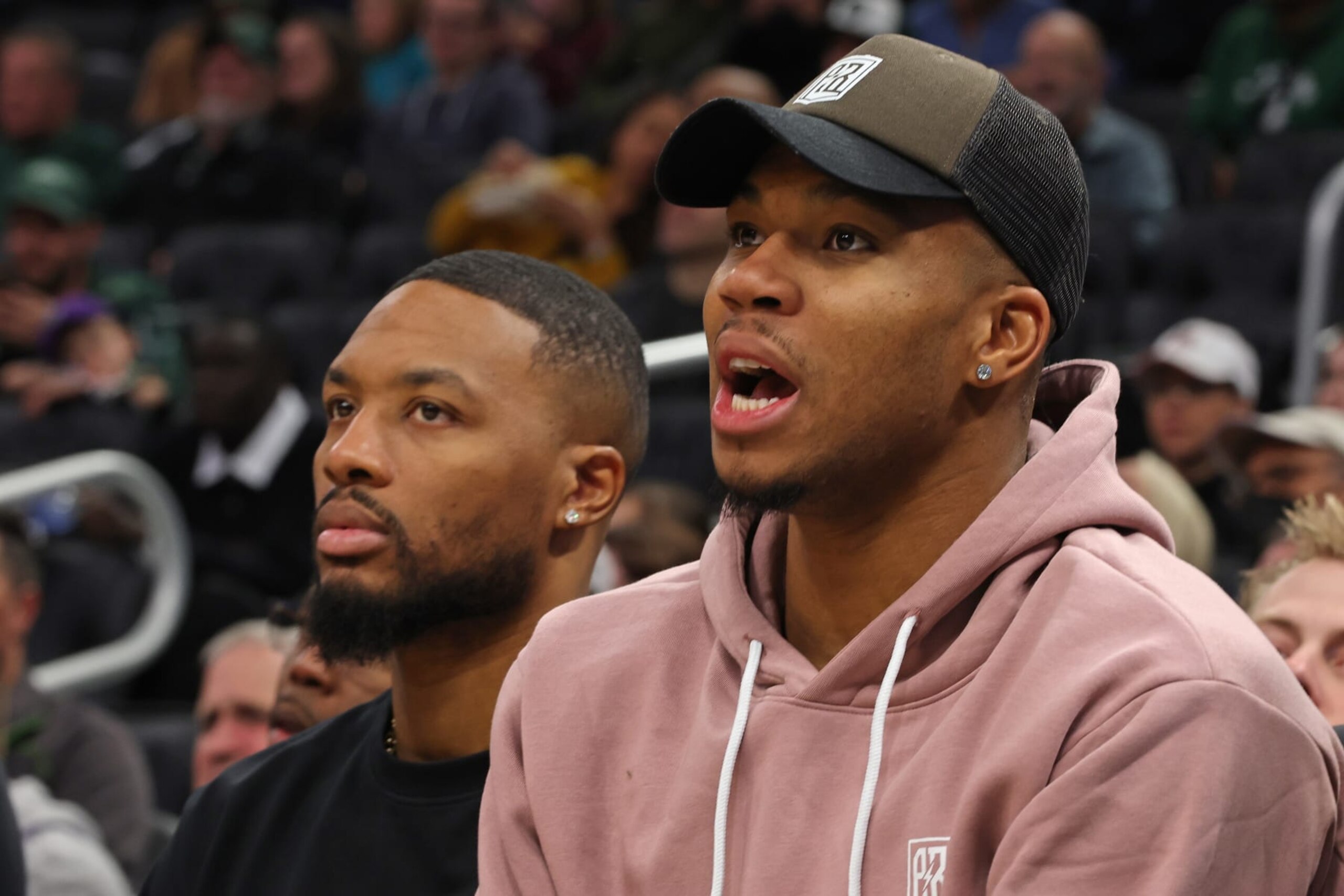 MILWAUKEE, WISCONSIN - OCTOBER 08: Damian Lillard #0 and Giannis Antetokounmpo #34 of the Milwaukee Bucks watch action during the first half of a game of a preseason game against the Chicago Bulls at Fiserv Forum on October 08, 2023 in Milwaukee, Wisconsin. NOTE TO USER: User expressly acknowledges and agrees that, by downloading and or using this photograph, User is consenting to the terms and conditions of the Getty Images License Agreement. (Photo by Stacy Revere/Getty Images)