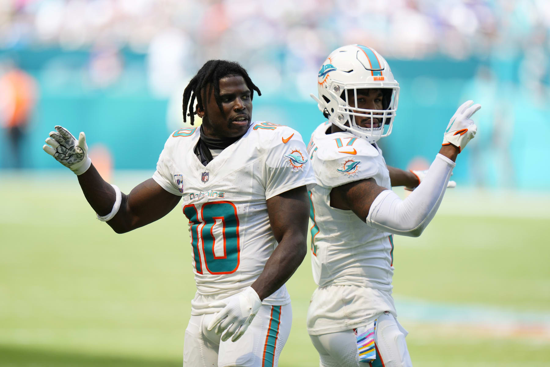 MIAMI GARDENS, FLORIDA - OCTOBER 08: Tyreek Hill #10 celebrates with Jaylen Waddle #17 of the Miami Dolphins after gaining yardage against the New York Giants during the second quarter at Hard Rock Stadium on October 08, 2023 in Miami Gardens, Florida. (Photo by Rich Storry/Getty Images)
