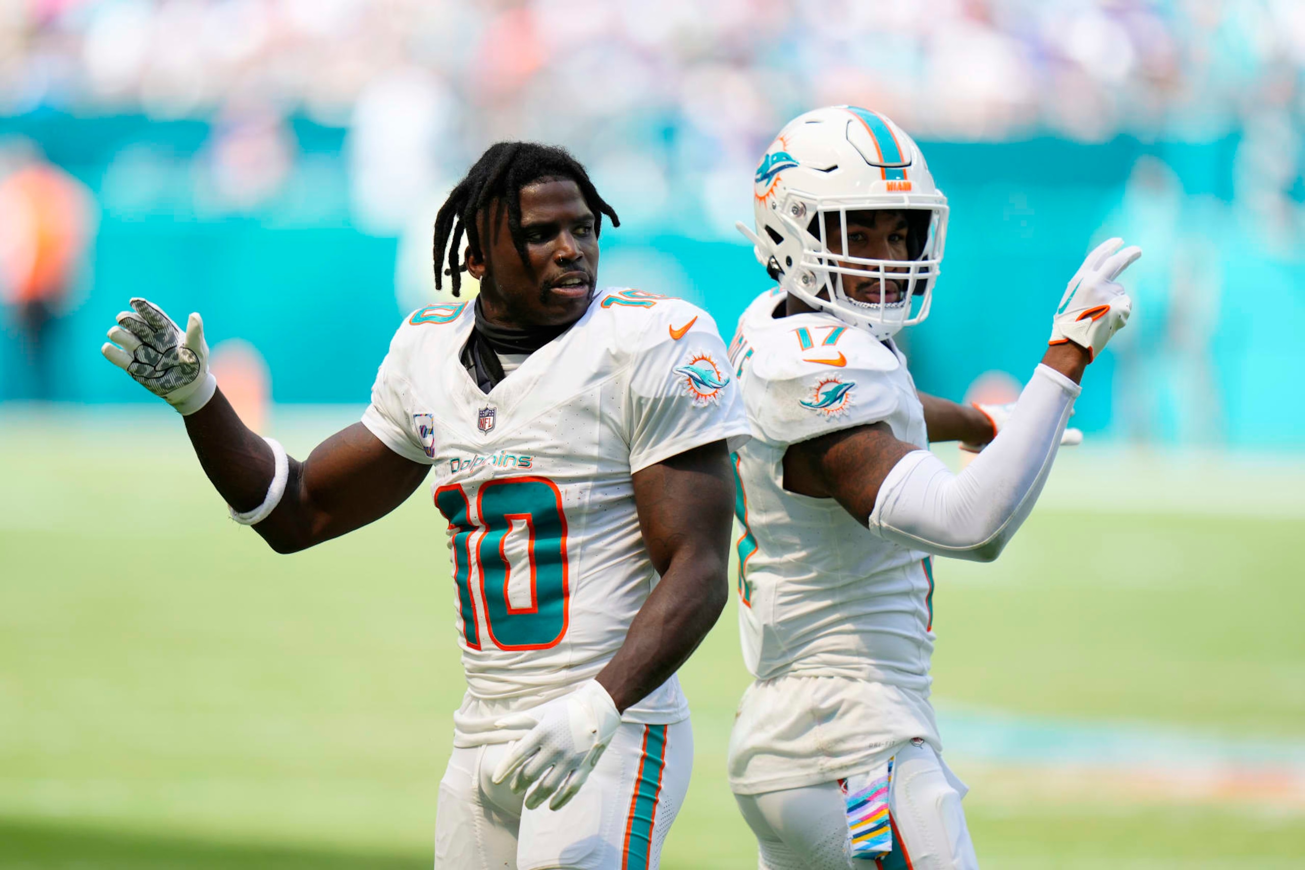 MIAMI GARDENS, FLORIDA - OCTOBER 08: Tyreek Hill #10 celebrates with Jaylen Waddle #17 of the Miami Dolphins after gaining yardage against the New York Giants during the second quarter at Hard Rock Stadium on October 08, 2023 in Miami Gardens, Florida. (Photo by Rich Storry/Getty Images) MIAMI GARDENS, FLORIDA - OCTOBER 08: Tyreek Hill #10 celebrates with Jaylen Waddle #17 of the Miami Dolphins after gaining yardage against the New York Giants during the second quarter at Hard Rock Stadium on October 08, 2023 in Miami Gardens, Florida. (Photo by Rich Storry/Getty Images)
