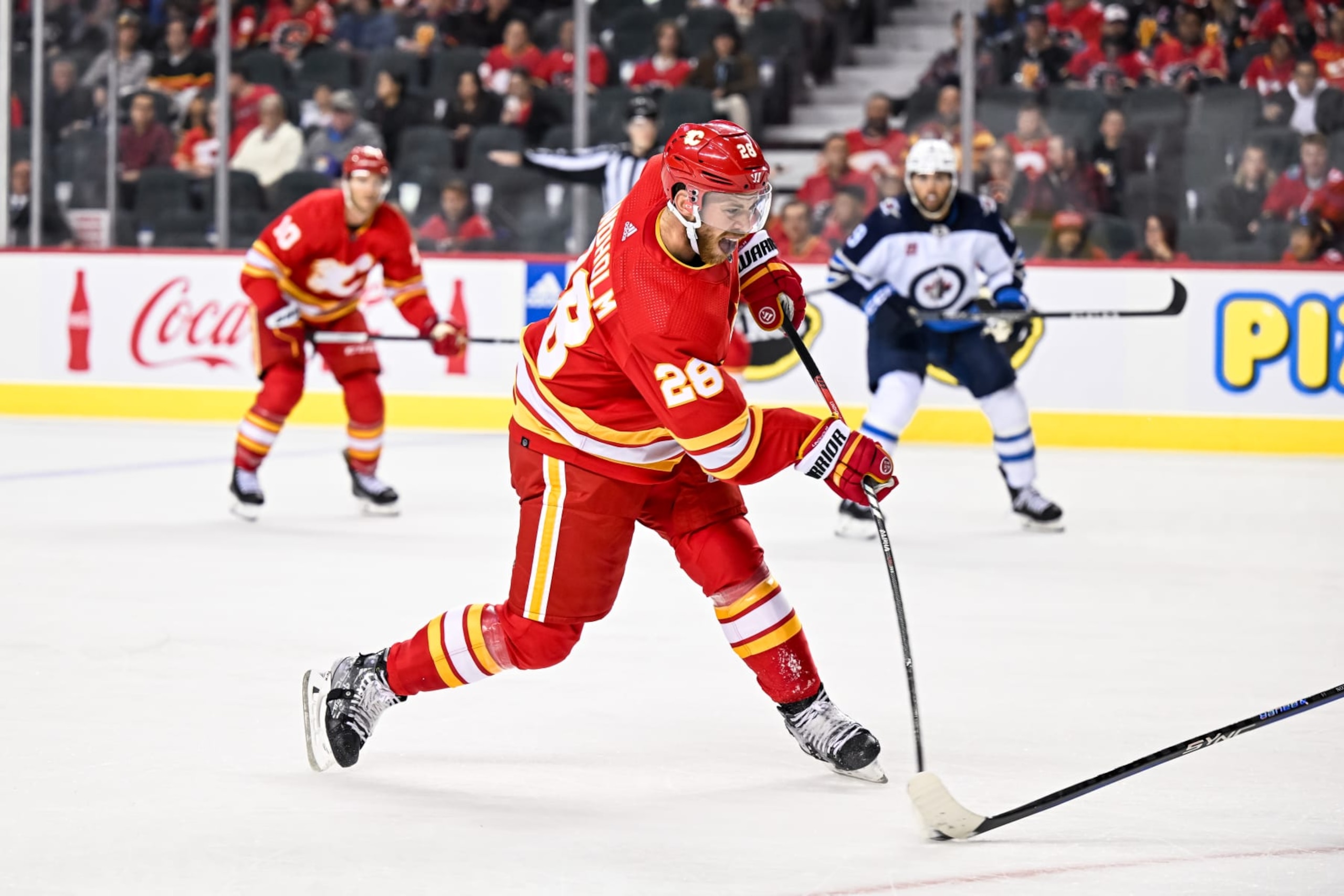 CALGARY, AB - OCTOBER 02: Calgary Flames Center Elias Lindholm (28) takes a shot during the first period of an NHL preseason game between the Calgary Flames and the Winnipeg Jets on October 2, 2023, at the Scotiabank Saddledome in Calgary, AB. (Photo by Brett Holmes/Icon Sportswire via Getty Images) CALGARY, AB - OCTOBER 02: Calgary Flames Center Elias Lindholm (28) takes a shot during the first period of an NHL preseason game between the Calgary Flames and the Winnipeg Jets on October 2, 2023, at the Scotiabank Saddledome in Calgary, AB. (Photo by Brett Holmes/Icon Sportswire via Getty Images)