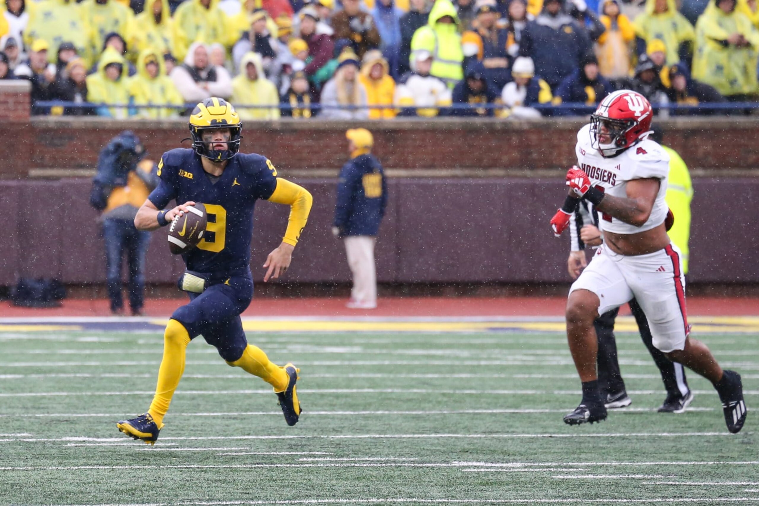 ANN ARBOR, MI - OCTOBER 14:  Michigan Wolverines quarterback J.J. McCarthy (9) looks for a receiver while he scrambles away from a pursuing Indiana defender during the third quarter of a Big Ten Conference college football game between the Indiana Hoosiers and the Michigan Wolverines on October 14, 2023 at Michigan Stadium in Ann Arbor, Michigan.  (Photo by Scott W. Grau/Icon Sportswire via Getty Images)