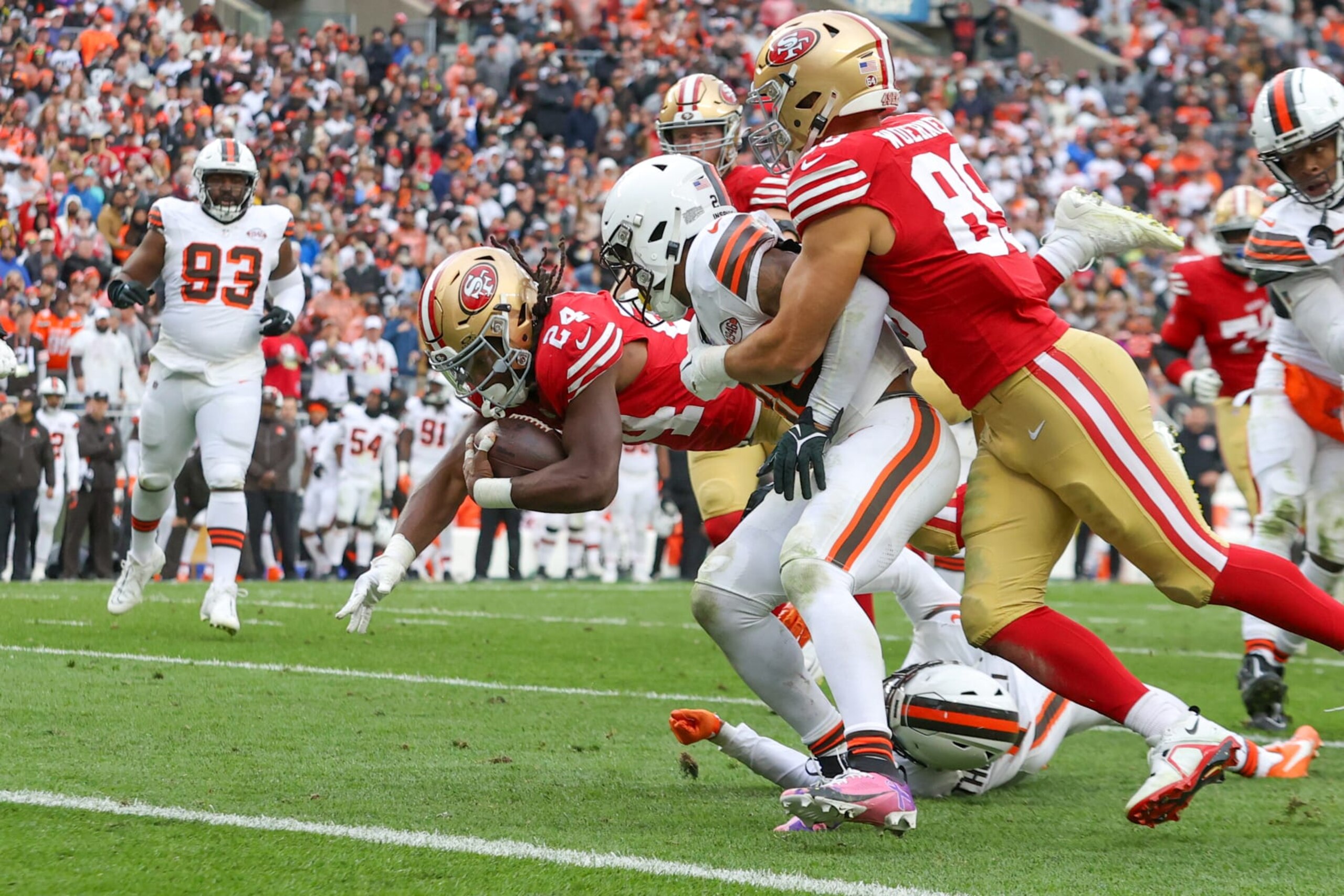 CLEVELAND, OH - OCTOBER 15: San Francisco 49ers running back Jordan Mason (24) scores on an 8-yard run during the fourth quarter of the National Football League game between the San Francisco 49ers and Cleveland Browns on October 15, 2023, at Cleveland Browns Stadium in Cleveland, OH. (Photo by Frank Jansky/Icon Sportswire via Getty Images)