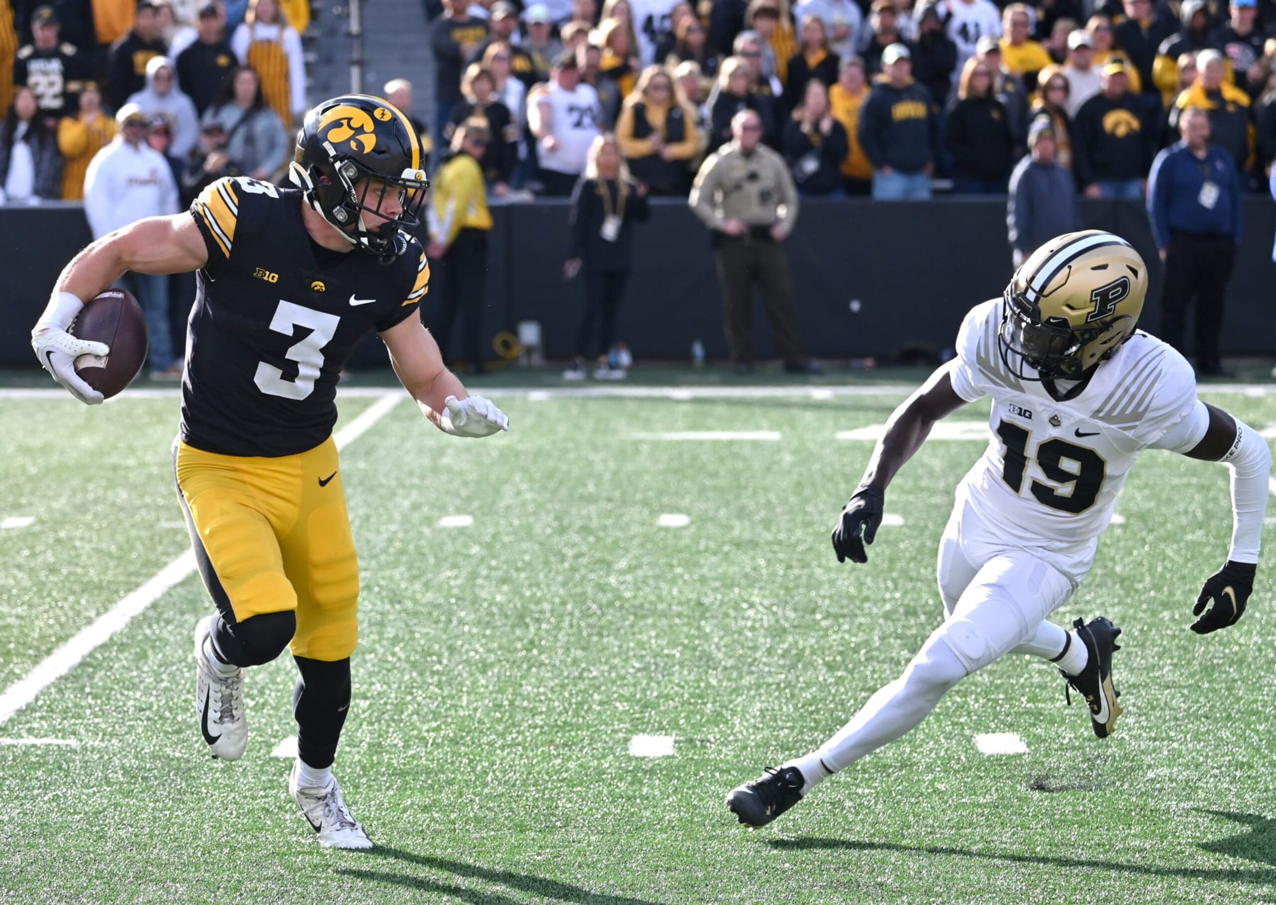 IOWA CITY, IA - OCTOBER 07: Iowa Hawkeyes left corner back Cooper DeJean (3) runs back a uni as Purdue defensive back Botros Alisandro (19) defends  during a college football game between the Purdue Boilermakers and the Iowa Hawkeyes on October 07, 2023, at Kinnick Stadium in Iowa City, Ia. (Photo by Keith Gillett/Icon Sportswire via Getty Images)