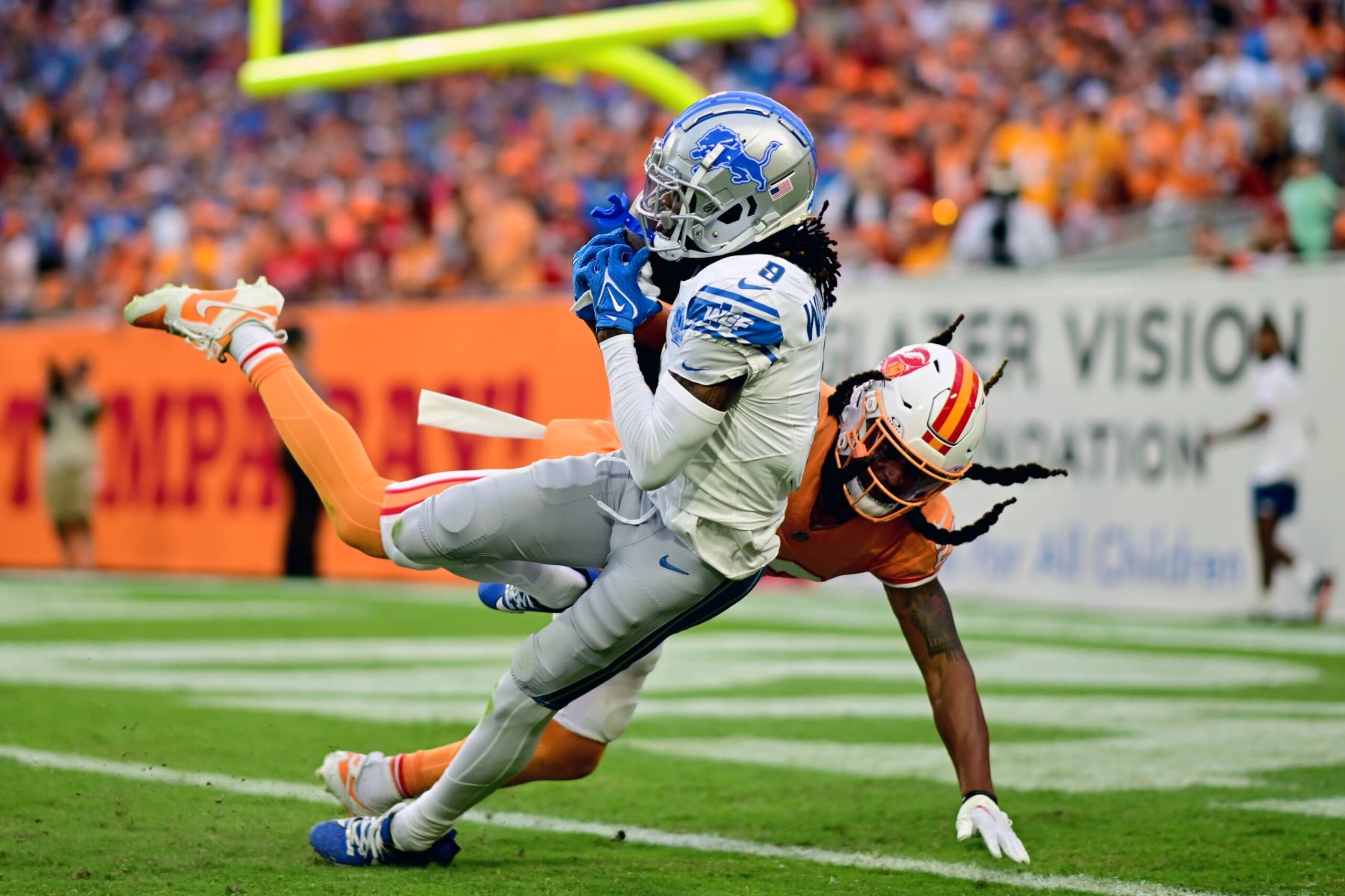 TAMPA, FLORIDA - OCTOBER 15: Jameson Williams #9 of the Detroit Lions catches a touchdown over Ryan Neal #23 of the Tampa Bay Buccaneers during the third quarter at Raymond James Stadium on October 15, 2023 in Tampa, Florida. (Photo by Julio Aguilar/Getty Images)