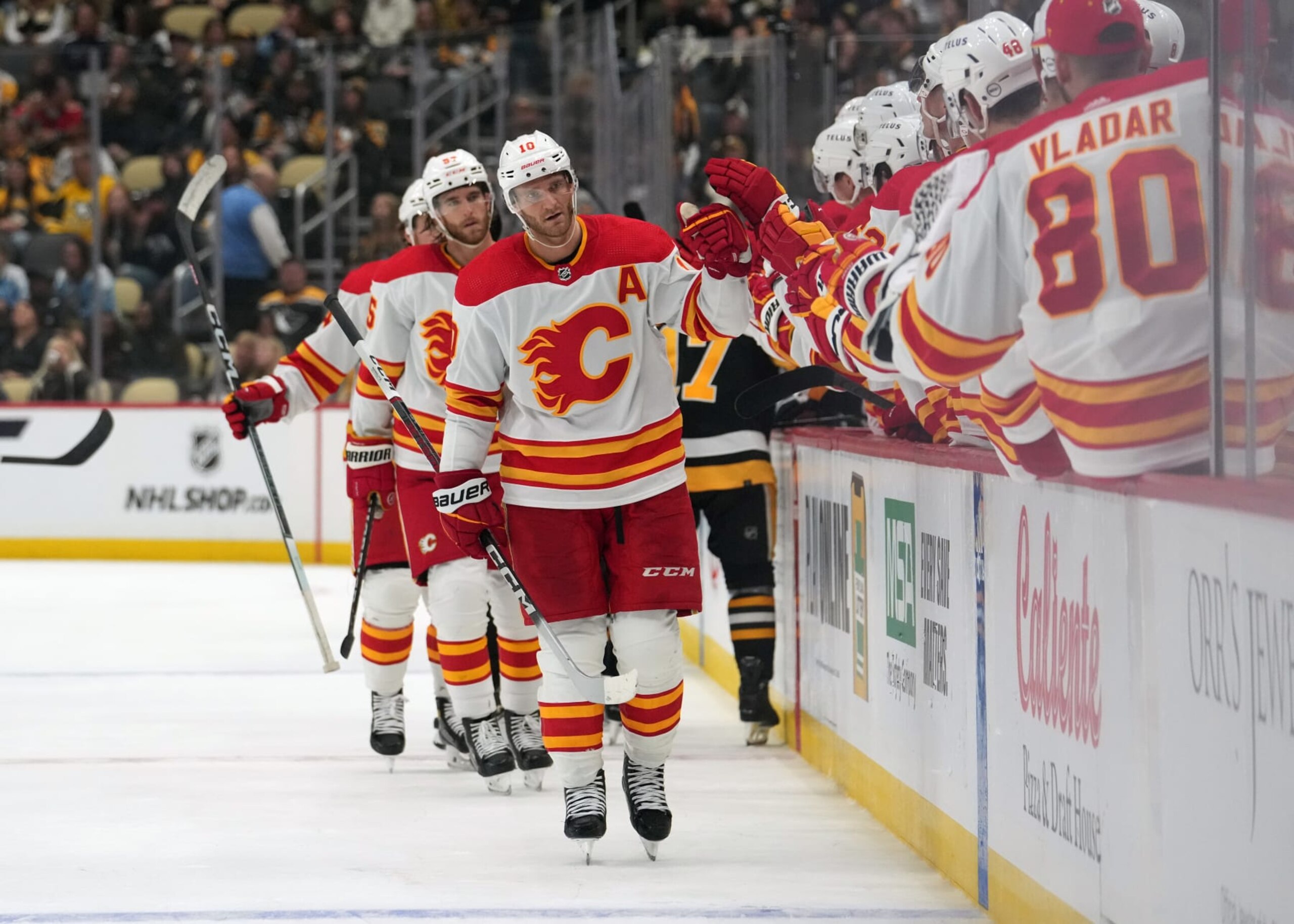 PITTSBURGH, PENNSYLVANIA - OCTOBER 14: Jonathan Huberdeau #10 of the Calgary Flames celebrates a goal in the third period against the Pittsburgh Penguins at PPG PAINTS Arena on October 14, 2023 in Pittsburgh, Pennsylvania. (Photo by Jason Mowry/Getty Images)
