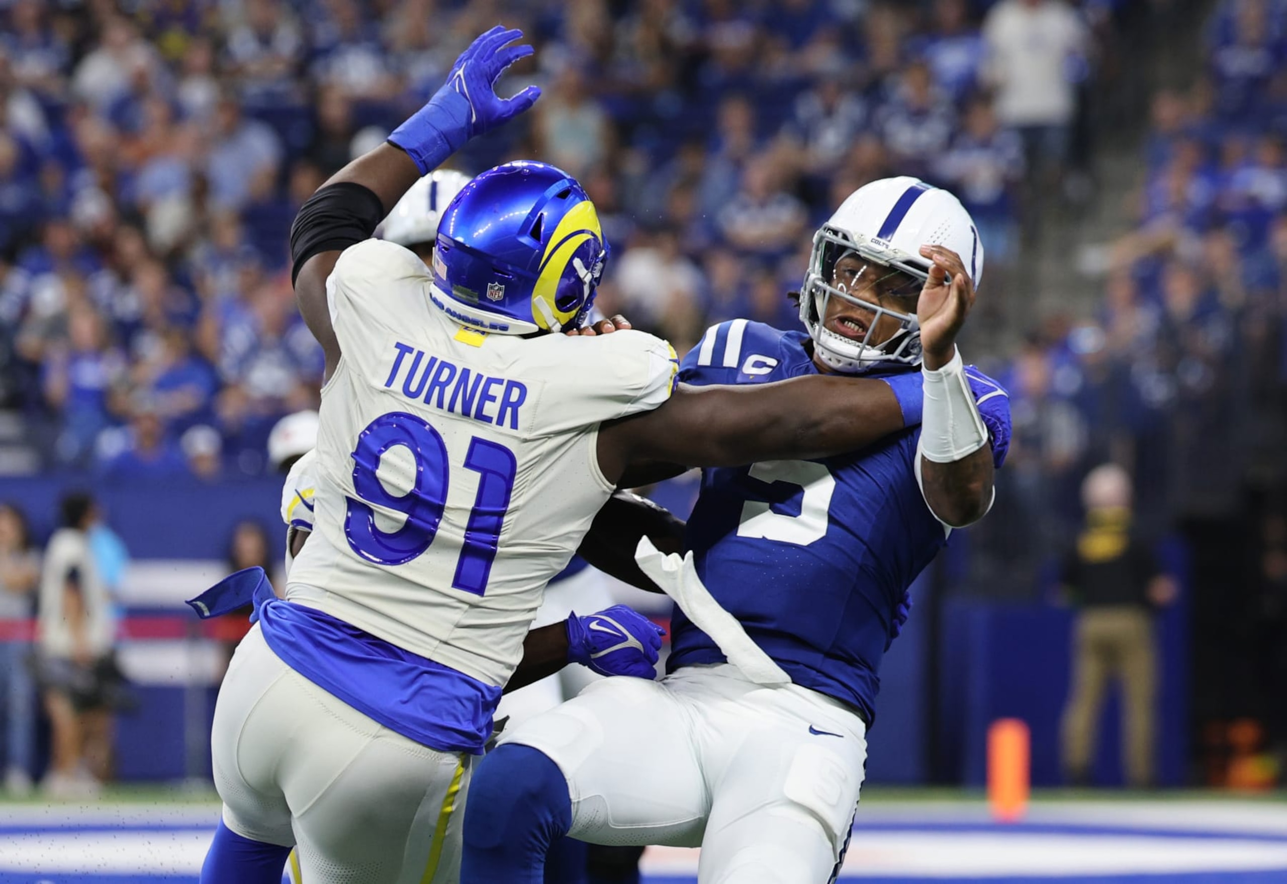 INDIANAPOLIS, INDIANA - OCTOBER 01: Anthony Richardson #5 of the Indianapolis Colts i shit by Kobie Turner #91 of the Los Angeles Rams during the second half at Lucas Oil Stadium on October 01, 2023 in Indianapolis, Indiana. Roughing the passer was called on the play. (Photo by Michael Hickey/Getty Images) INDIANAPOLIS, INDIANA - OCTOBER 01: Anthony Richardson #5 of the Indianapolis Colts i shit by Kobie Turner #91 of the Los Angeles Rams during the second half at Lucas Oil Stadium on October 01, 2023 in Indianapolis, Indiana. Roughing the passer was called on the play. (Photo by Michael Hickey/Getty Images)