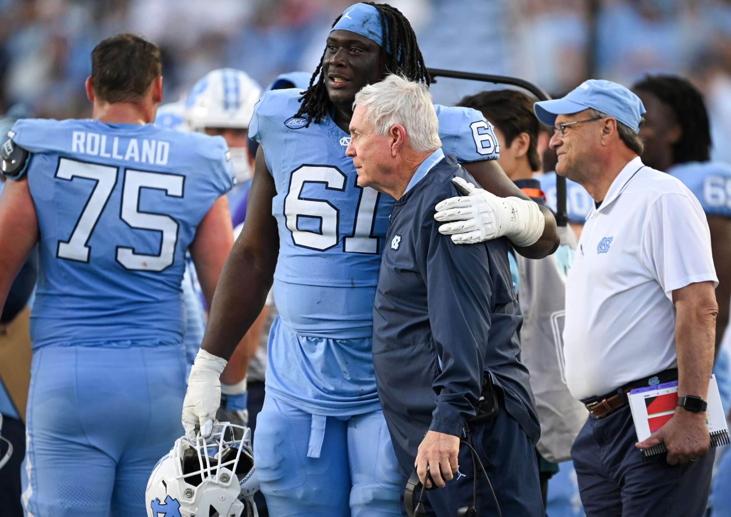 CHAPEL HILL, NORTH CAROLINA - OCTOBER 07: Diego Pounds #61 hugs head coach Mack Brown of the North Carolina Tar Heels during the second half of their game against the Syracuse Orange at Kenan Memorial Stadium on October 07, 2023 in Chapel Hill, North Carolina. The Tar Heels won 40-7. (Photo by Grant Halverson/Getty Images)