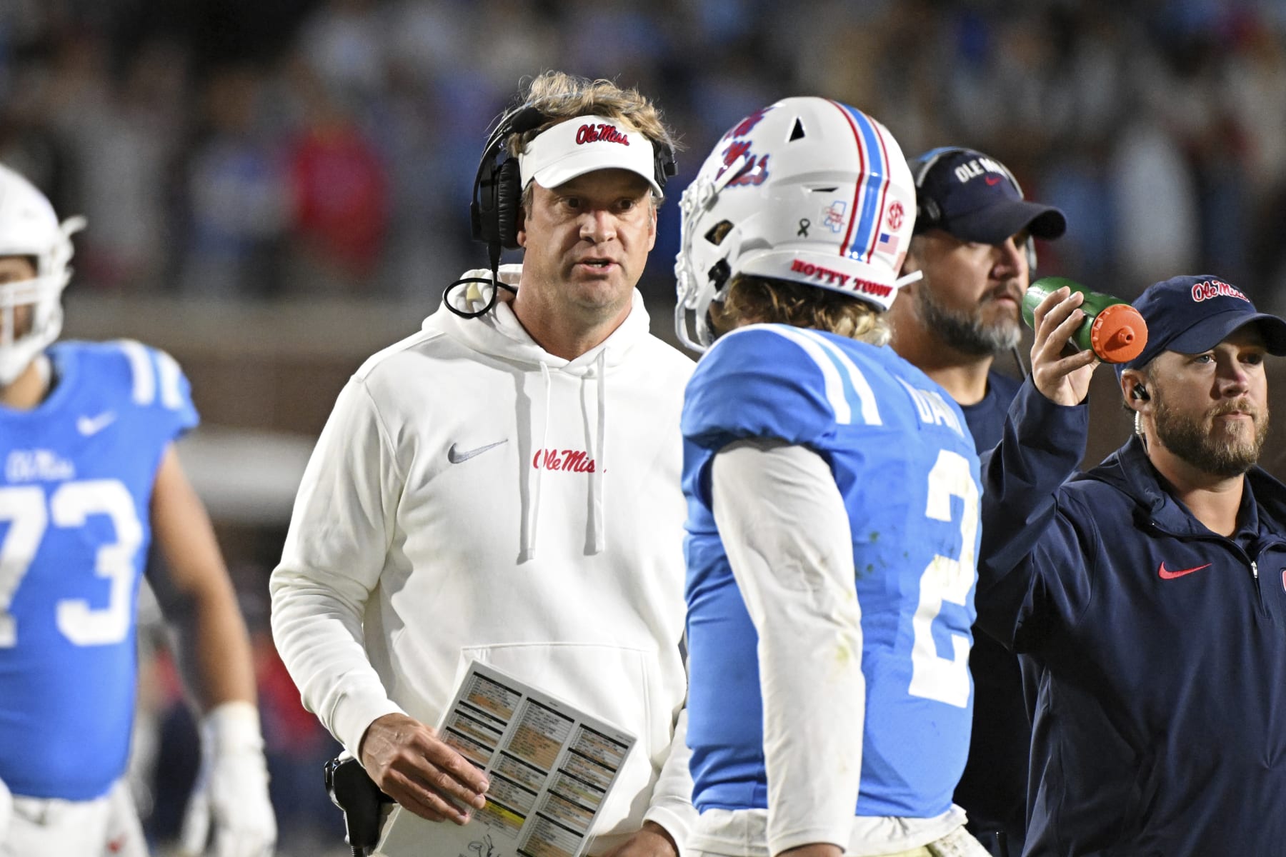 Mississippi head coach Lane Kiffin talks to quarterback Jaxson Dart (2) during the second half of an NCAA college football game against Arkansas in Oxford, Miss., Saturday, Oct. 7, 2023. Mississippi won 27-20. (AP Photo/Thomas Graning)