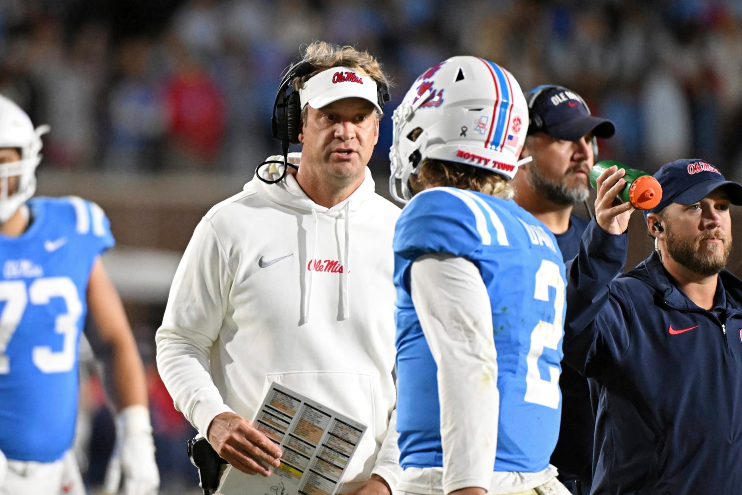 Mississippi head coach Lane Kiffin talks to quarterback Jaxson Dart (2) during the second half of an NCAA college football game against Arkansas in Oxford, Miss., Saturday, Oct. 7, 2023. Mississippi won 27-20. (AP Photo/Thomas Graning)