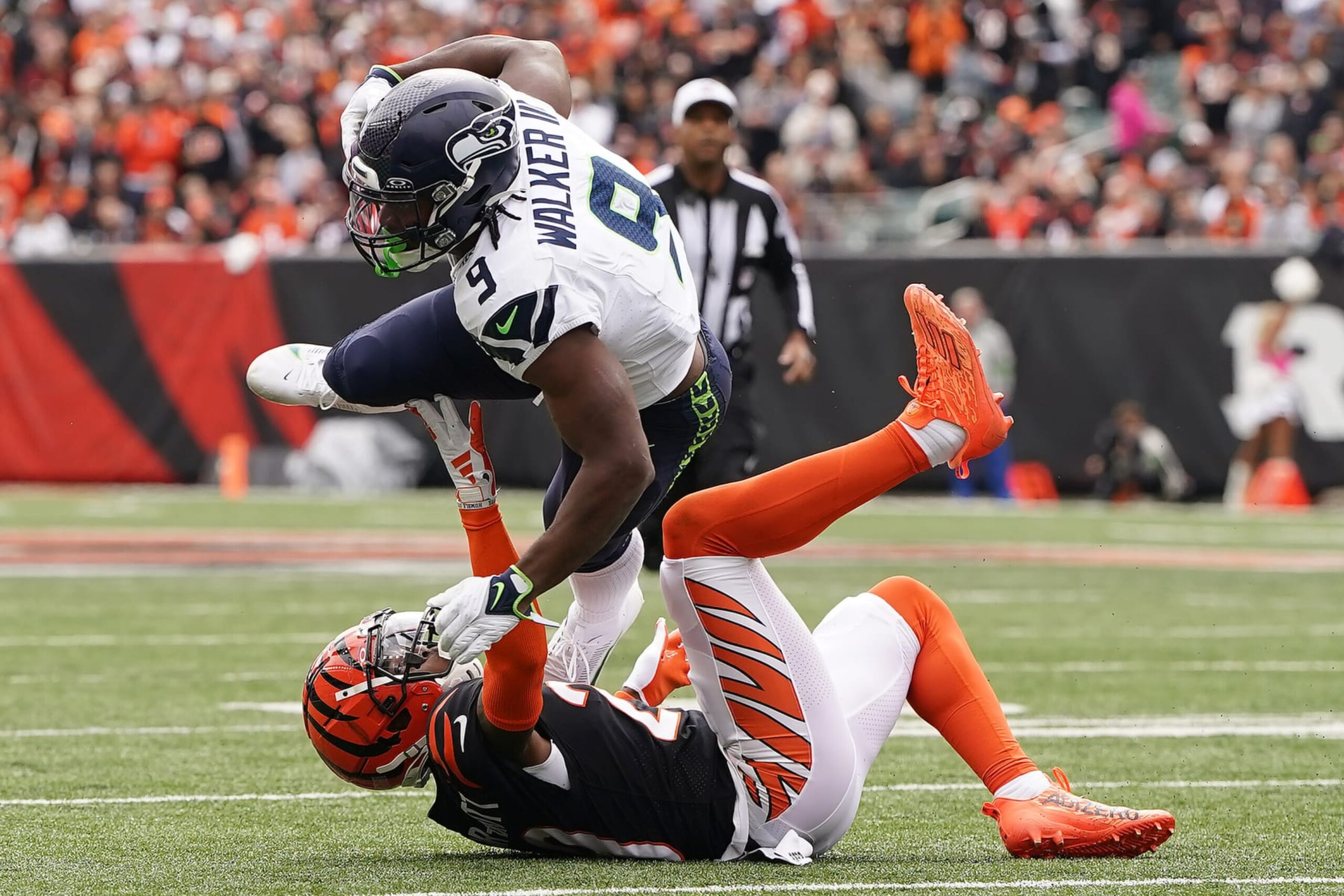 CINCINNATI, OHIO - OCTOBER 15: Kenneth Walker III #9 of the Seattle Seahawks is tackled by Cam Taylor-Britt #29 of the Cincinnati Bengals during the first quarter at Paycor Stadium on October 15, 2023 in Cincinnati, Ohio. (Photo by Dylan Buell/Getty Images)
