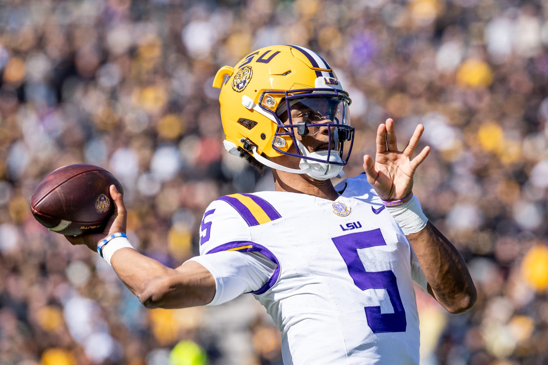 COLUMBIA, MISSOURI - OCTOBER 7: Jayden Daniels #5 of the LSU Tigers warms up during a timeout against the Missouri Tigers at Faurot Field/Memorial Stadium on October 7, 2023 in Columbia, Missouri. (Photo by Michael Hickey/Getty Images)