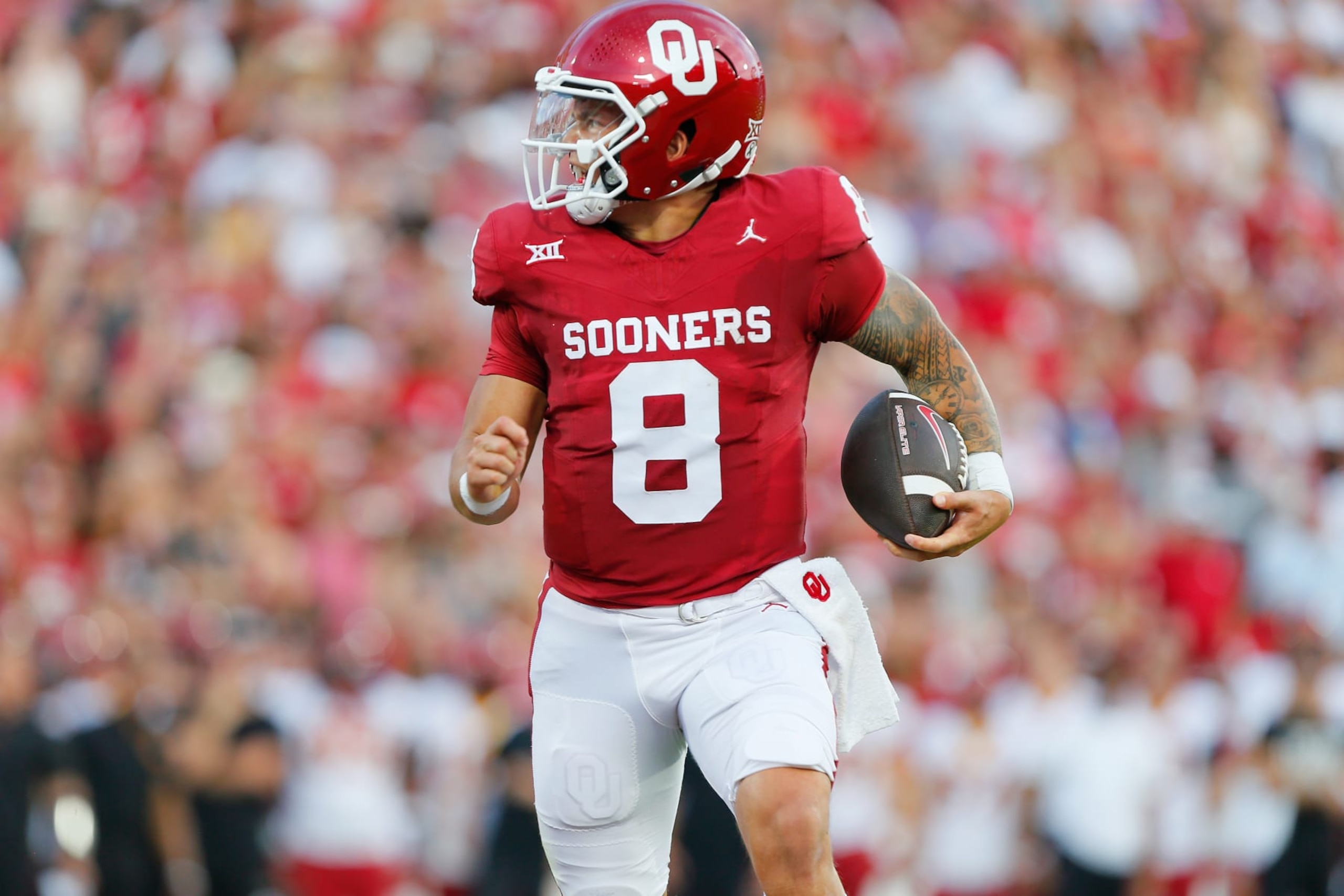 NORMAN, OKLAHOMA - SEPTEMBER 30:  Quarterback Dillon Gabriel #8 of the Oklahoma Sooners breaks a tackle for a touchdown against the Iowa State Cyclones in the first quarter at Gaylord Family Oklahoma Memorial Stadium on September 30, 2023 in Norman, Oklahoma.  Oklahoma won 50-20.  (Photo by Brian Bahr/Getty Images)
