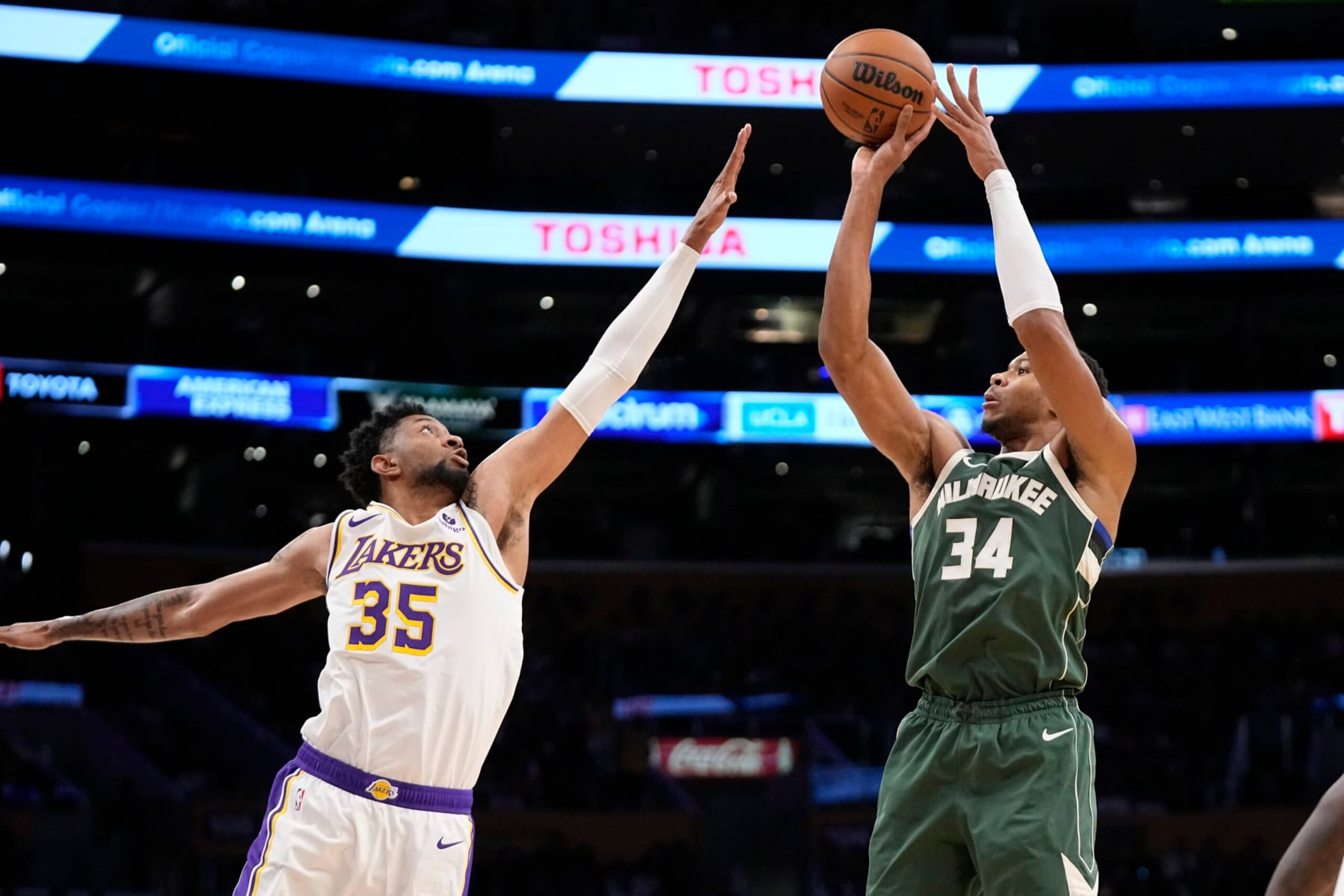 Milwaukee Bucks forward Giannis Antetokounmpo, right, shoots as Los Angeles Lakers forward Christian Wood defends during the first half of an NBA preseason basketball game Sunday, Oct. 15, 2023, in Los Angeles. (AP Photo/Mark J. Terrill)
