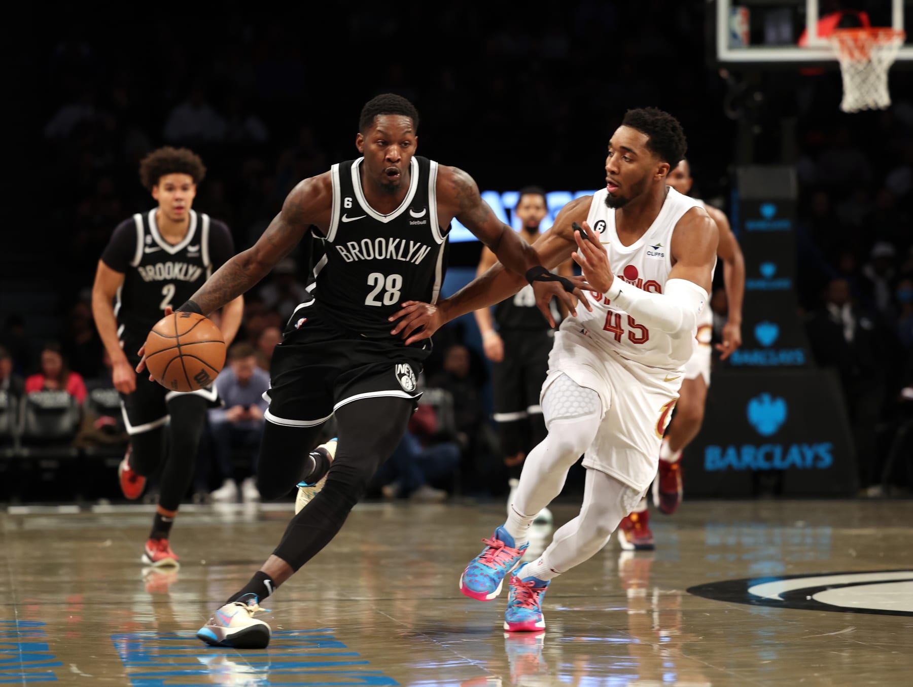 NEW YORK, NEW YORK - MARCH 21:   Dorian Finney-Smith #28 of the Brooklyn Nets dribbles against Donovan Mitchell #45 of the Cleveland Cavaliers during their game at Barclays Center on March 21, 2023 in New York City.  User expressly acknowledges and agrees that, by downloading and or using this photograph, User is consenting to the terms and conditions of the Getty Images License Agreement.  (Photo by Al Bello/Getty Images)