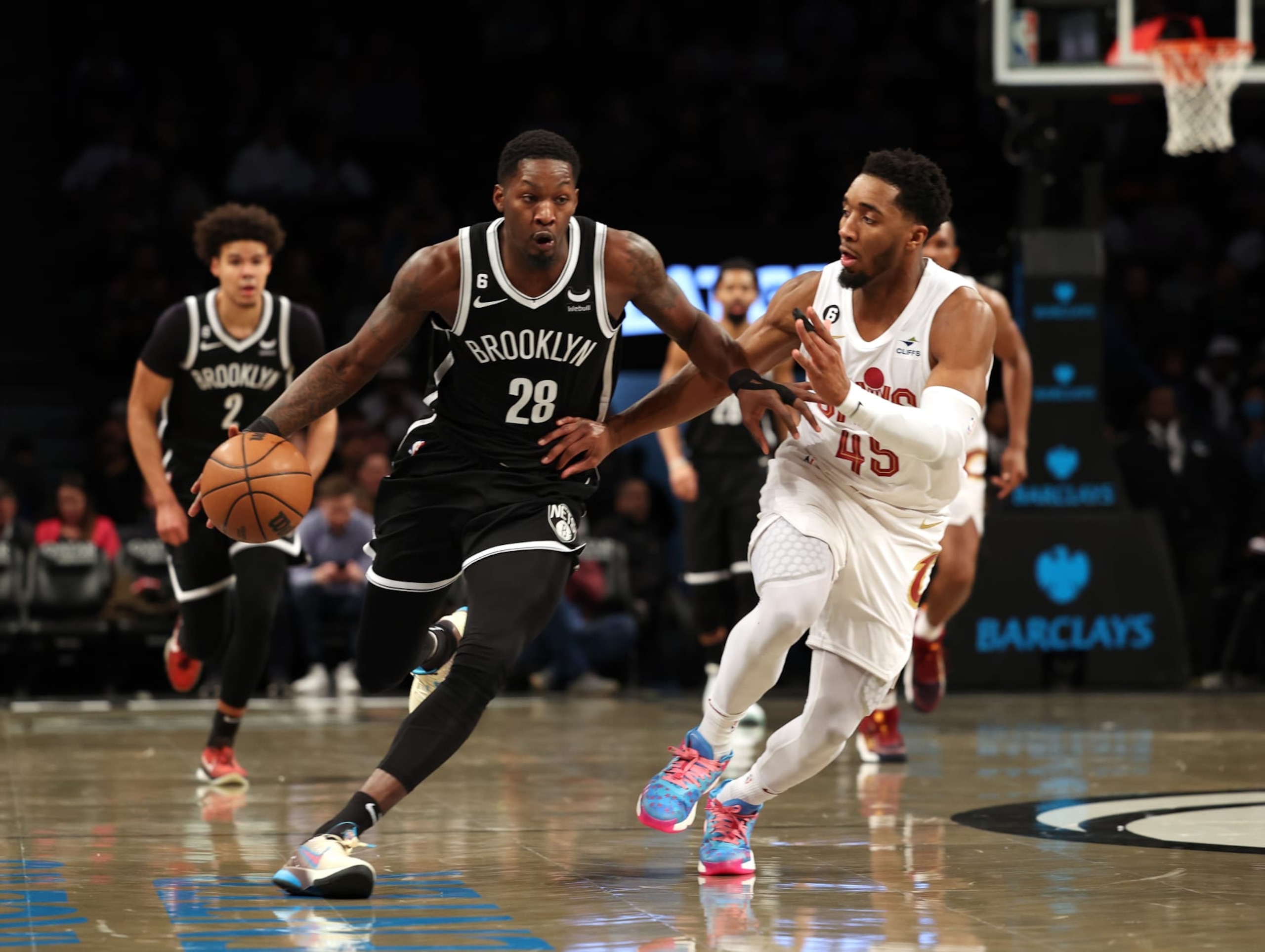 NEW YORK, NEW YORK - MARCH 21: Dorian Finney-Smith #28 of the Brooklyn Nets dribbles against Donovan Mitchell #45 of the Cleveland Cavaliers during their game at Barclays Center on March 21, 2023 in New York City. User expressly acknowledges and agrees that, by downloading and or using this photograph, User is consenting to the terms and conditions of the Getty Images License Agreement. (Photo by Al Bello/Getty Images) NEW YORK, NEW YORK - MARCH 21: Dorian Finney-Smith #28 of the Brooklyn Nets dribbles against Donovan Mitchell #45 of the Cleveland Cavaliers during their game at Barclays Center on March 21, 2023 in New York City. User expressly acknowledges and agrees that, by downloading and or using this photograph, User is consenting to the terms and conditions of the Getty Images License Agreement. (Photo by Al Bello/Getty Images)