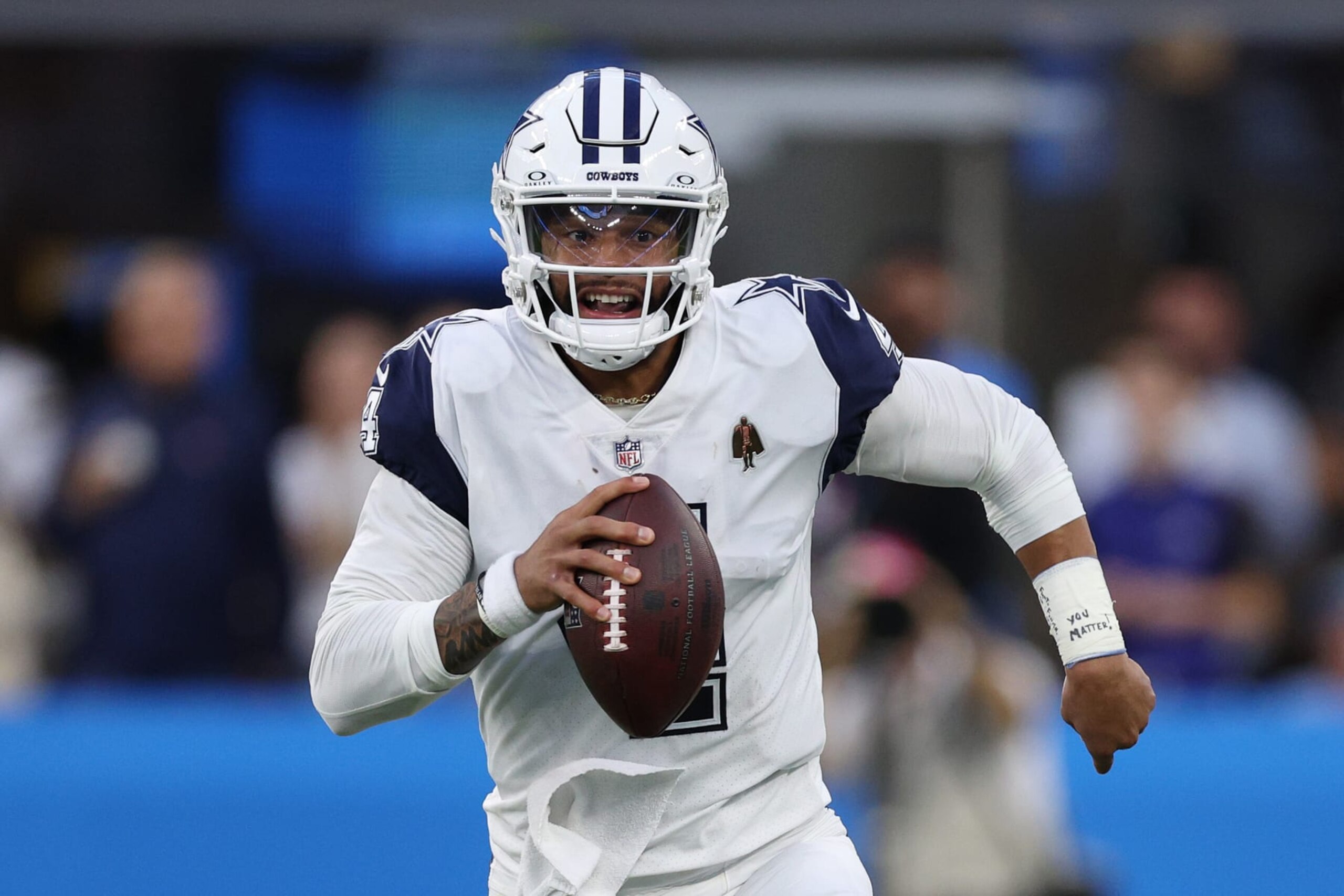 INGLEWOOD, CALIFORNIA - OCTOBER 16: Dak Prescott #4 of the Dallas Cowboys scrambles in the first half against Los Angeles Chargers at SoFi Stadium on October 16, 2023 in Inglewood, California. (Photo by Harry How/Getty Images)