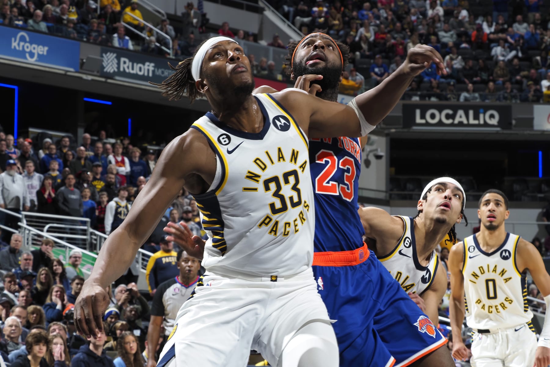 INDIANAPOLIS, IN - DECEMBER 18: Myles Turner #33 of the Indiana Pacers plays defense on Mitchell Robinson #23 of the New York Knicks during the game on December 18, 2022 at Gainbridge Fieldhouse in Indianapolis, Indiana. NOTE TO USER: User expressly acknowledges and agrees that, by downloading and or using this Photograph, user is consenting to the terms and conditions of the Getty Images License Agreement. Mandatory Copyright Notice: Copyright 2022 NBAE (Photo by Ron Hoskins/NBAE via Getty Images)