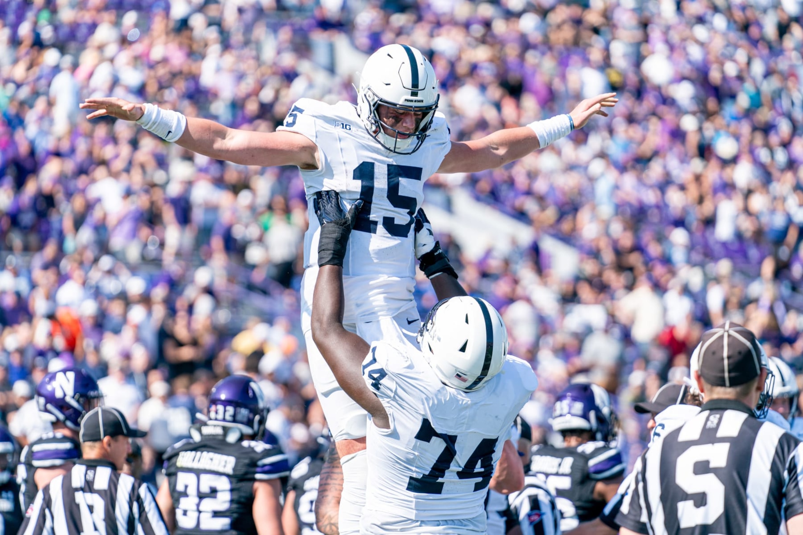 EVANSTON, IL - SEPTEMBER 30: Northwestern Wildcats offensive lineman Nick Herzog (74) lifts up Penn State Nittany Lions quarterback Drew Allar (15) while celebrating a play during the college football game between the Penn State Nittany Lions and the Northwestern Wildcats on September 30, 2023 at Ryan Field in Evanston, IL. (Photo by Ben Hsu/Icon Sportswire via Getty Images)