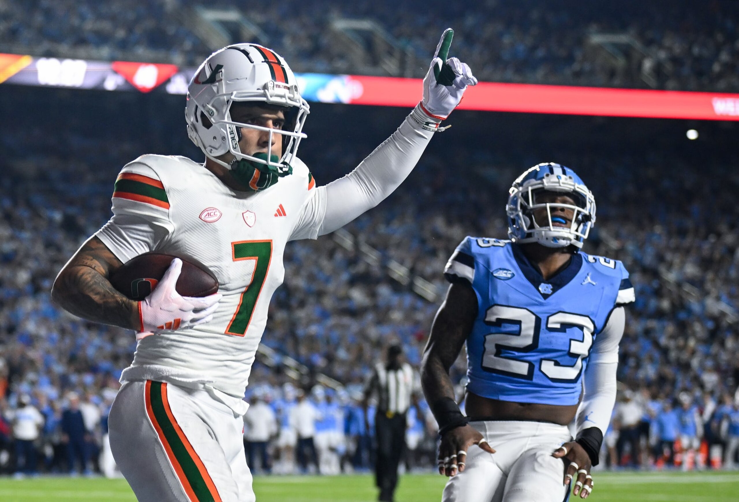 CHAPEL HILL, NORTH CAROLINA - OCTOBER 14: Xavier Restrepo #7 of the Miami Hurricanes reacts after scoring a touchdown against Power Echols #23 of the North Carolina Tar Heels during the first half of their game at Kenan Memorial Stadium on October 14, 2023 in Chapel Hill, North Carolina. (Photo by Grant Halverson/Getty Images)