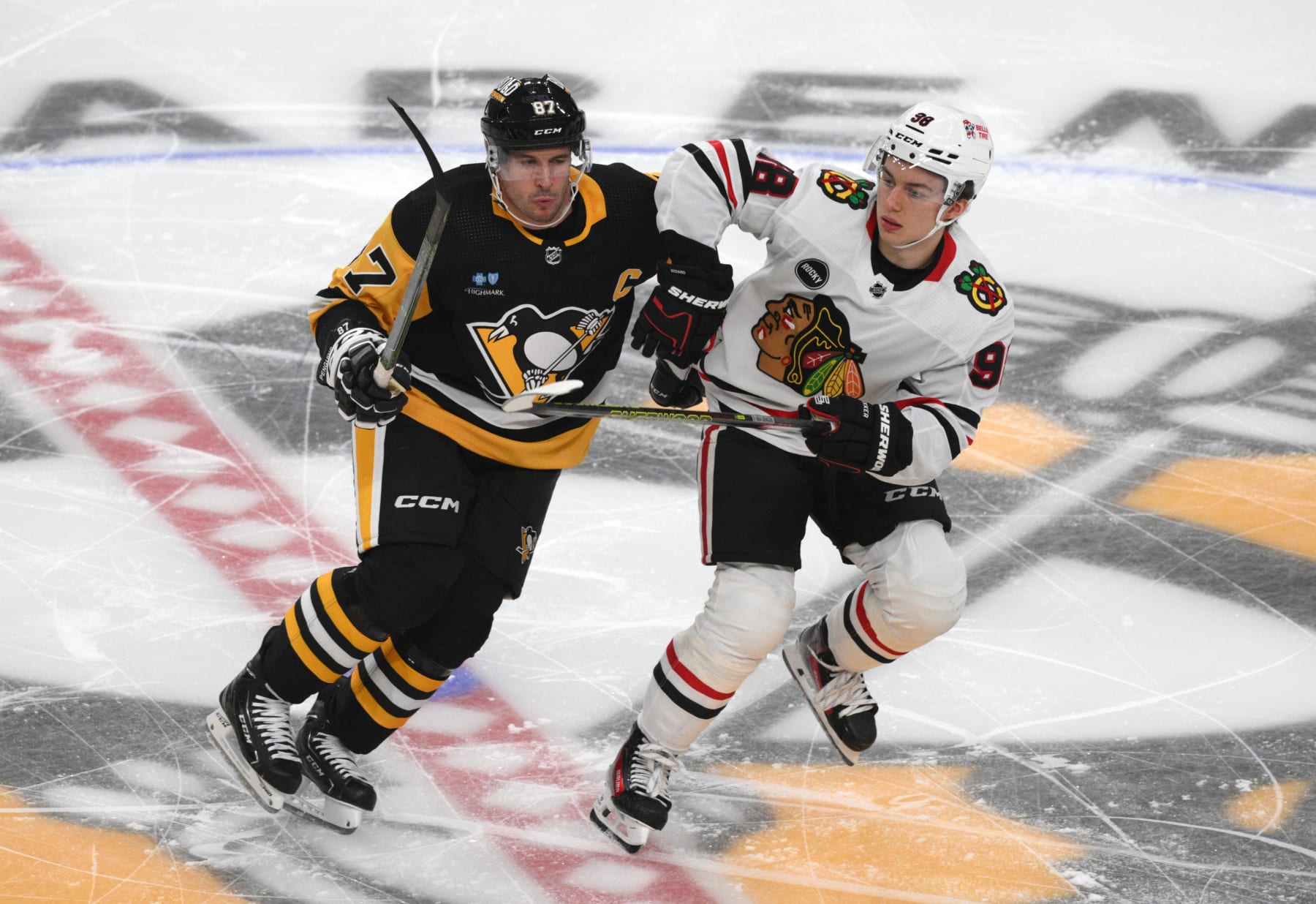 PITTSBURGH, PENNSYLVANIA - OCTOBER 10: Connor Bedard #98 of the Chicago Blackhawks skates against Sidney Crosby #87 of the Pittsburgh Penguins during the first period at PPG PAINTS Arena on October 10, 2023 in Pittsburgh, Pennsylvania. (Photo by Justin Berl/Getty Images)