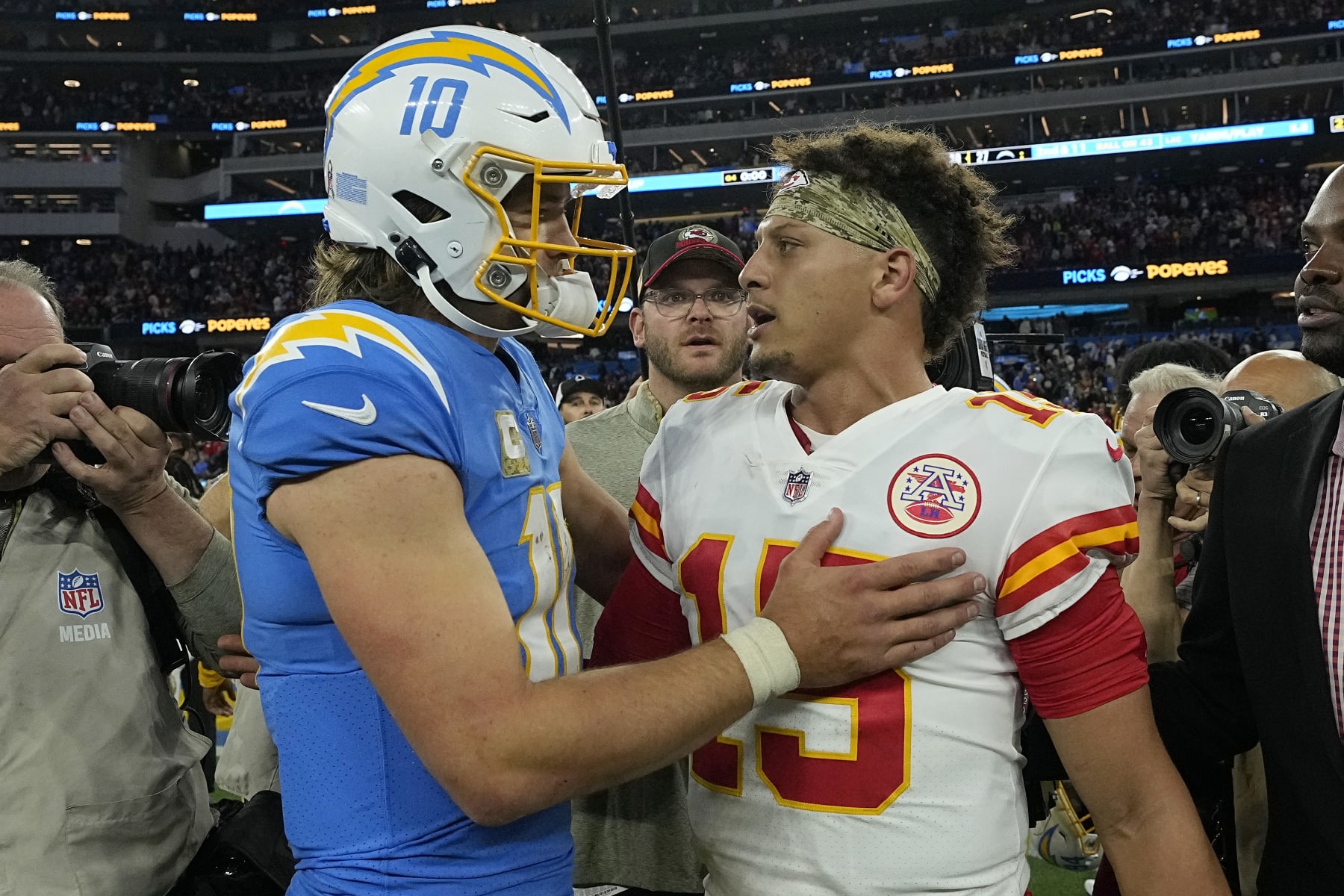 INGLEWOOD, CALIFORNIA - NOVEMBER 20: Justin Herbert #10 of the Los Angeles Chargers and Patrick Mahomes #15 of the Kansas City Chiefs embraces after the game at SoFi Stadium on November 20, 2022 in Inglewood, California. (Photo by Kevork Djansezian/Getty Images)
