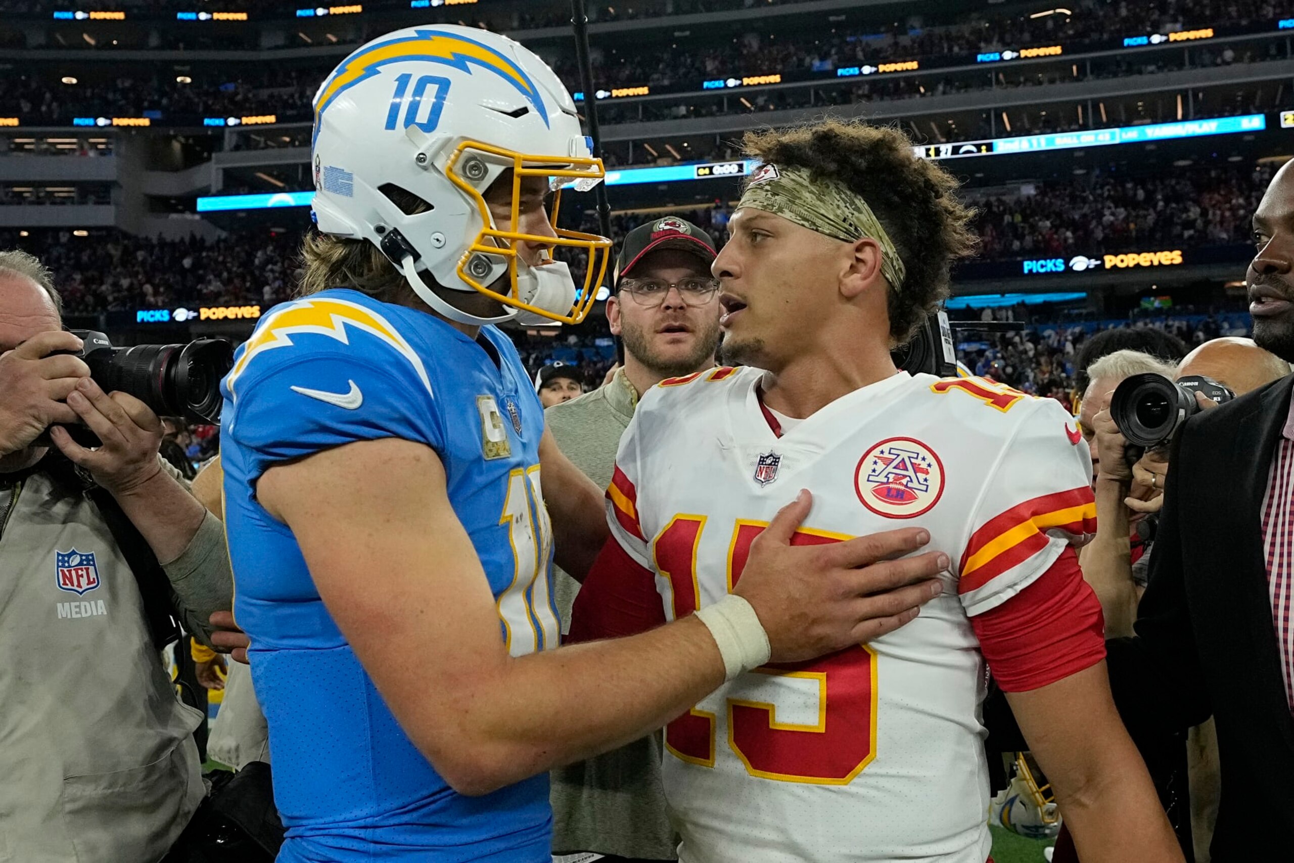 INGLEWOOD, CALIFORNIA - NOVEMBER 20: Justin Herbert #10 of the Los Angeles Chargers and Patrick Mahomes #15 of the Kansas City Chiefs embraces after the game at SoFi Stadium on November 20, 2022 in Inglewood, California. (Photo by Kevork Djansezian/Getty Images)