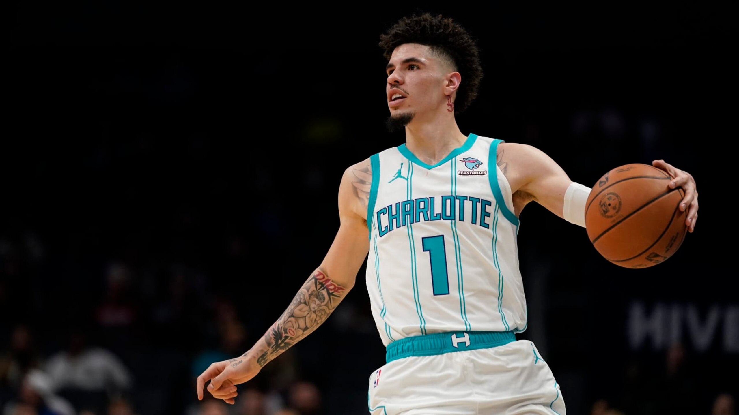 Charlotte Hornets guard LaMelo Ball dribbles the ball in the first half of an NBA basketball preseason game against the Oklahoma City Thunder, Sunday, Oct. 15, 2023, in Charlotte, N.C. (AP Photo/Erik Verduzco)