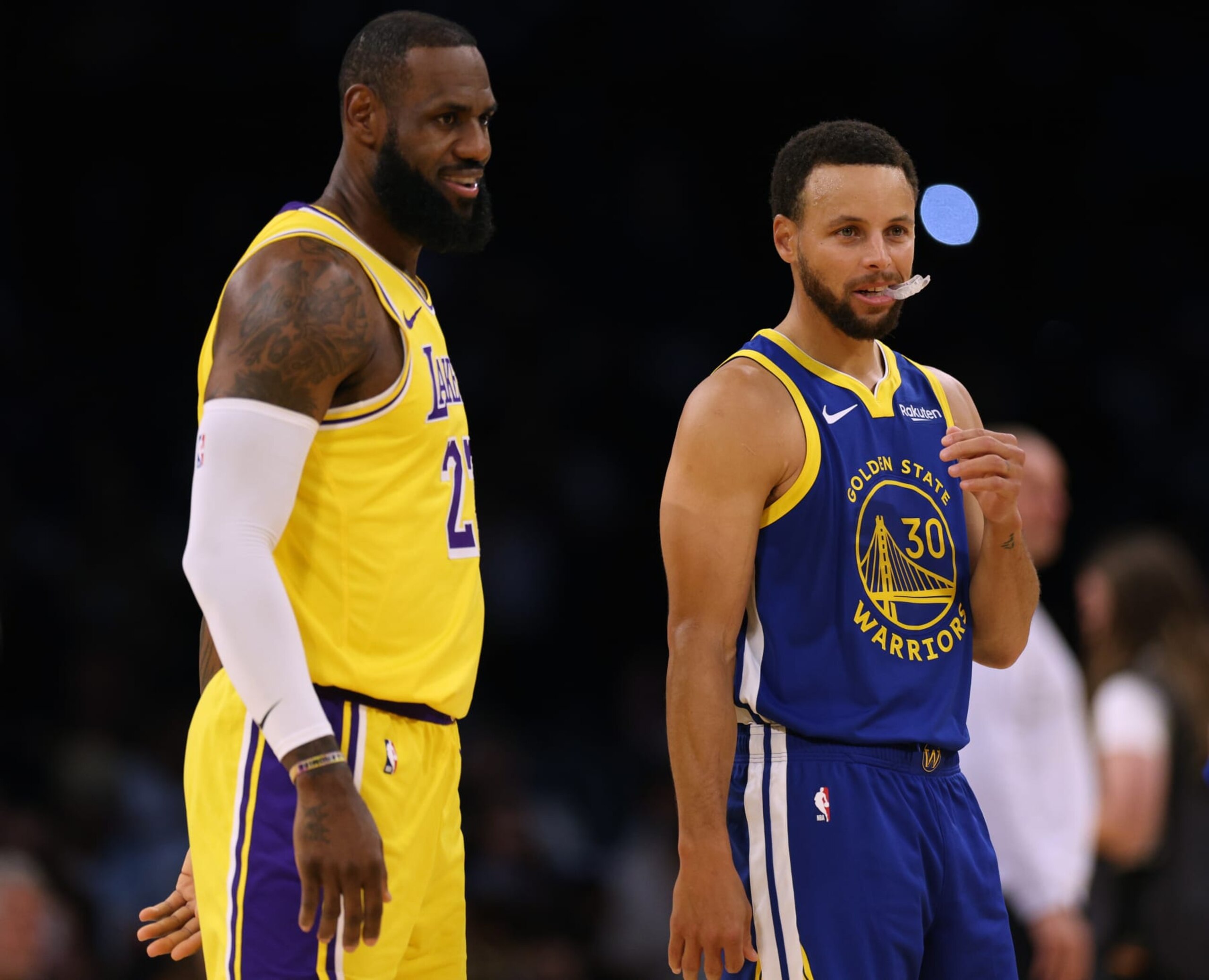 LOS ANGELES, CALIFORNIA - OCTOBER 13: LeBron James #23 of the Los Angeles Lakers and Stephen Curry #30 of the Golden State Warriors smile at center court before the start of a preseason game at Crypto.com Arena on October 13, 2023 in Los Angeles, California. (Photo by Harry How/Getty Images) NOTE TO USER: User expressly acknowledges and agrees that, by downloading and/or using this photograph, user is consenting to the terms and conditions of the Getty Images License Agreement. (Photo by Harry How/Getty Images)