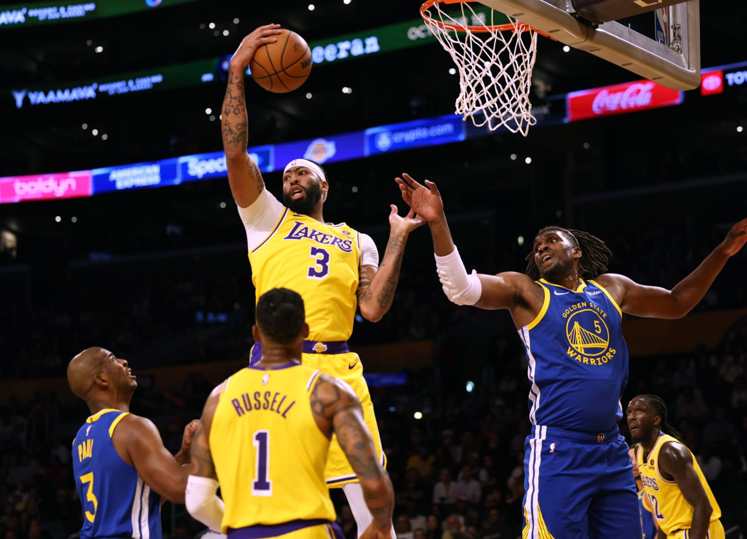 LOS ANGELES, CALIFORNIA - OCTOBER 13: Anthony Davis #3 of the Los Angeles Lakers grabs a rebound in front of Kevon Looney #5 and Chris Paul #3 of the Golden State Warriors with D'Angelo Russell #1 during the first half in a preseason game at Crypto.com Arena on October 13, 2023 in Los Angeles, California. (Photo by Harry How/Getty Images) NOTE TO USER: User expressly acknowledges and agrees that, by downloading and/or using this photograph, user is consenting to the terms and conditions of the Getty Images License Agreement.