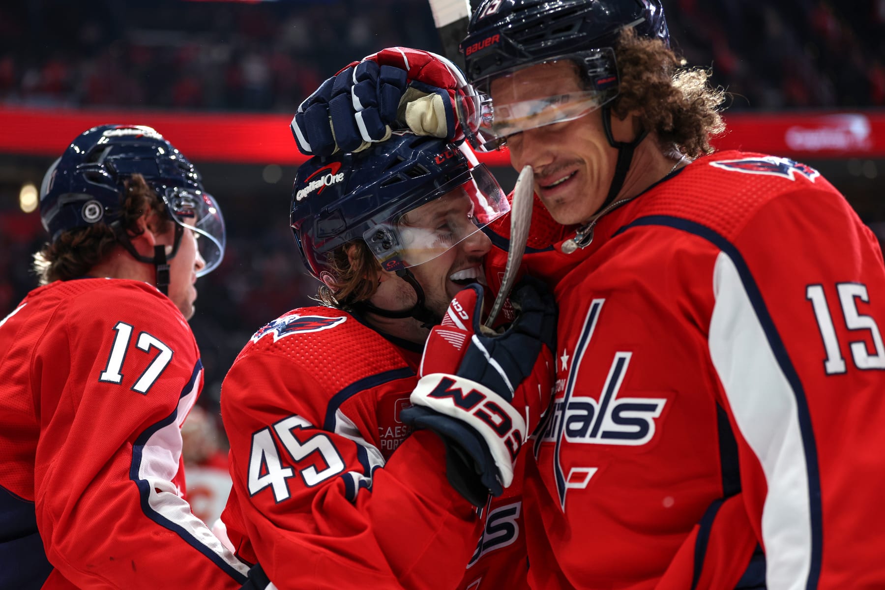 WASHINGTON, DC - OCTOBER 16: Matthew Phillips #45 of the Washington Capitals celebrates with teammate Sonny Milano #15 after scoring his first career NHL goal against the Calgary Flames during the second period at Capital One Arena on October 16, 2023 in Washington, DC. (Photo by Patrick Smith/Getty Images)