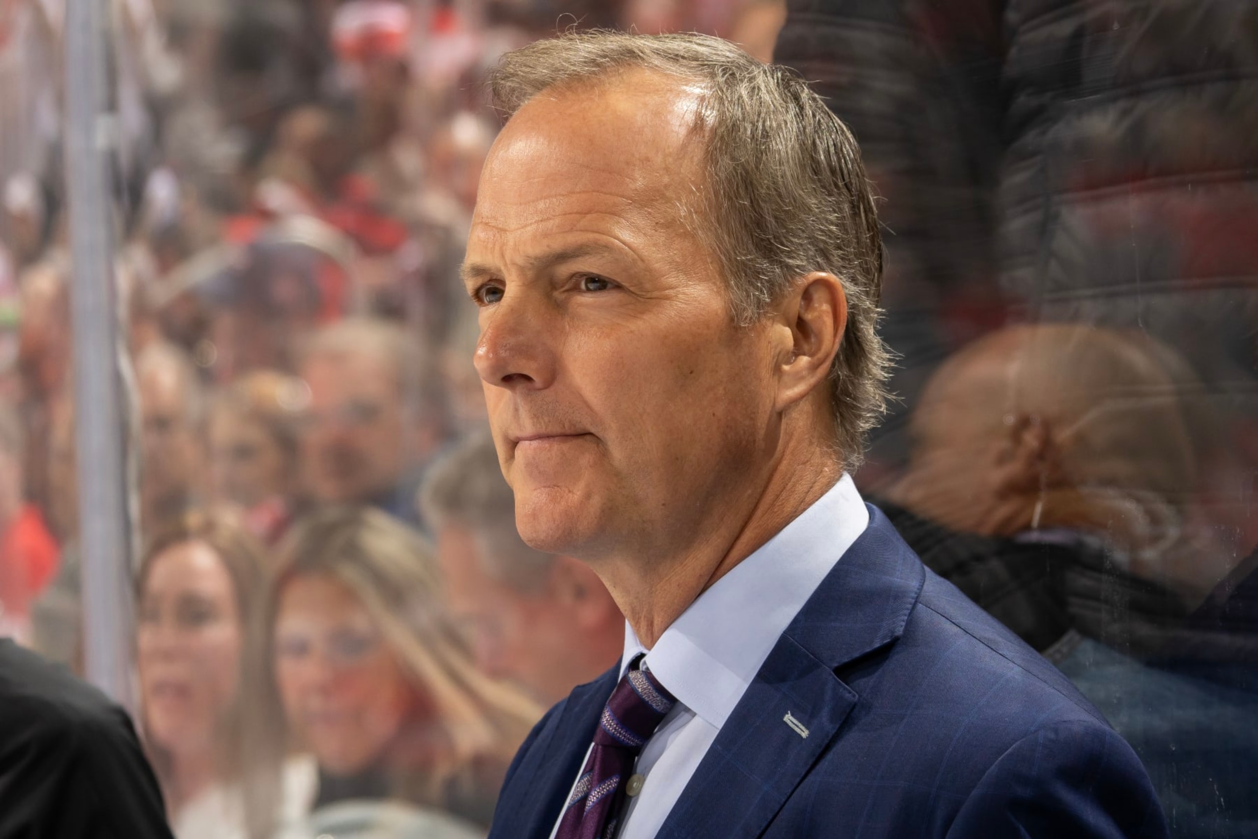 DETROIT, MI - OCTOBER 14: Head coach Jon Cooper of the Tampa Bay Lightning watches the action from the bench against the Detroit Red Wings in the first period of the home opener at Little Caesars Arena on October 14, 2023 in Detroit, Michigan. (Photo by Dave Reginek/NHLI via Getty Images)