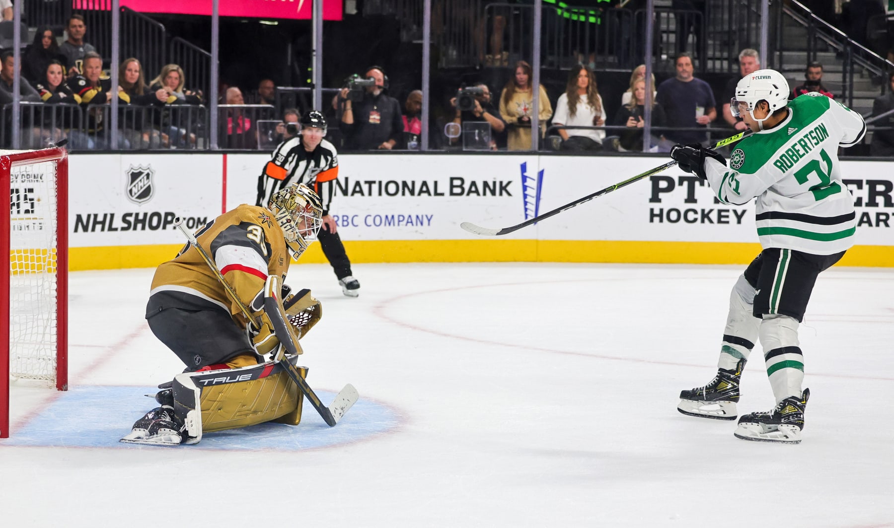 LAS VEGAS, NEVADA - OCTOBER 17: The puck bounces off the crossbar as Adin Hill #33 of the Vegas Golden Knights defends a shot by Jason Robertson #21 of the Dallas Stars during a shootout in their game at T-Mobile Arena on October 17, 2023 in Las Vegas, Nevada. The Golden Knights defeated the Stars 3-2 in a shootout. (Photo by Ethan Miller/Getty Images)