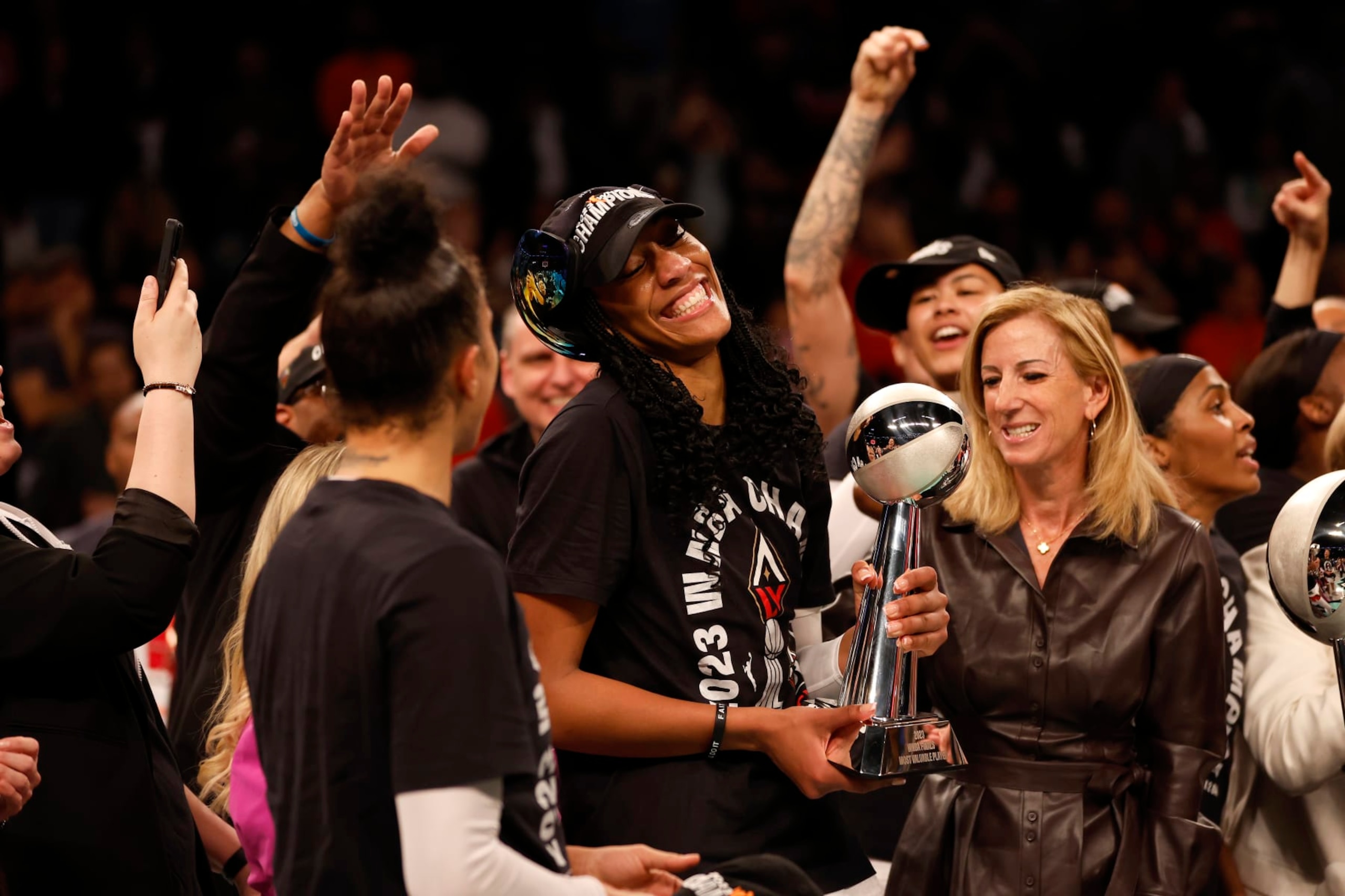 NEW YORK, NEW YORK - OCTOBER 18: A'ja Wilson #22 of the Las Vegas Aces celebrates with the MVP trophy after defeating the New York Liberty during Game Four of the 2023 WNBA Finals at Barclays Center on October 18, 2023 in New York City. The Aces defeated the Liberty 70-69. (Photo by Sarah Stier/Getty Images)