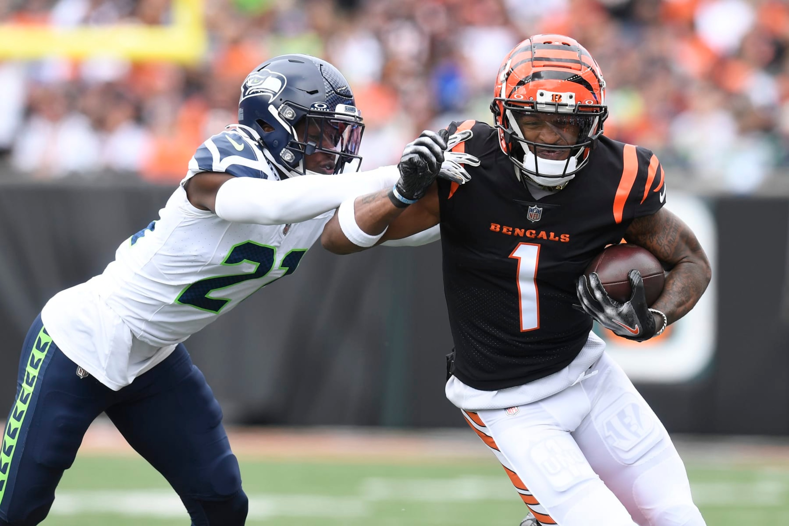 CINCINNATI, OH - OCTOBER 15: Seattle Seahawks Cornerback Devon Witherspoon (21) shoves Cincinnati Bengals Wide Receiver Ja'Marr Chase (1) out of bounds during the NFL game between the Seattle Seahawks and the Cincinnati Bengals on October 15, 2023, at Paycor Stadium in Cincinnati, Ohio. (Photo by Michael Allio/Icon Sportswire via Getty Images)