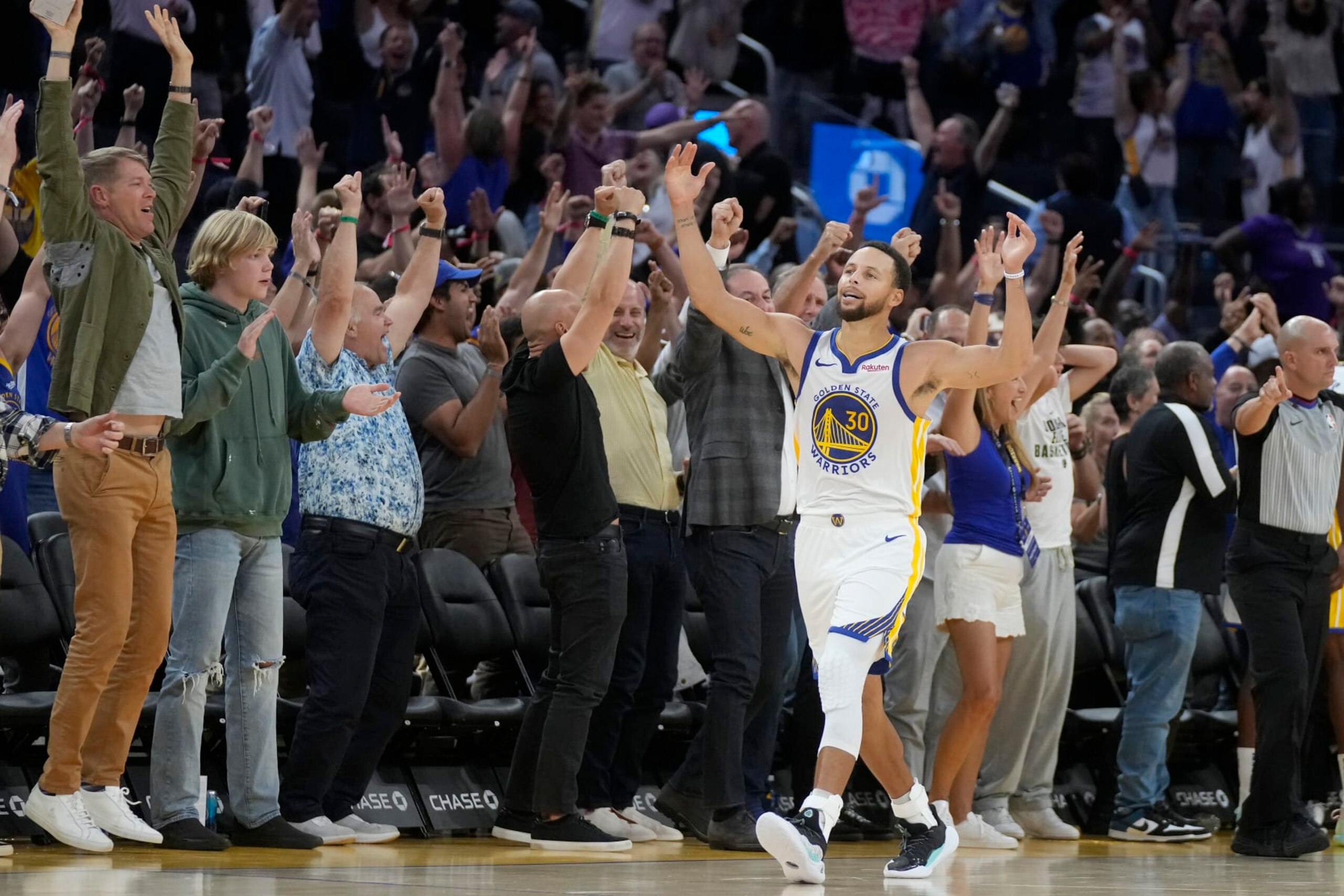 Golden State Warriors guard Stephen Curry celebrates in front of fans after the Warriors defeated the Sacramento Kings in an NBA preseason basketball game in San Francisco, Wednesday, Oct. 18, 2023. (AP Photo/Jeff Chiu)