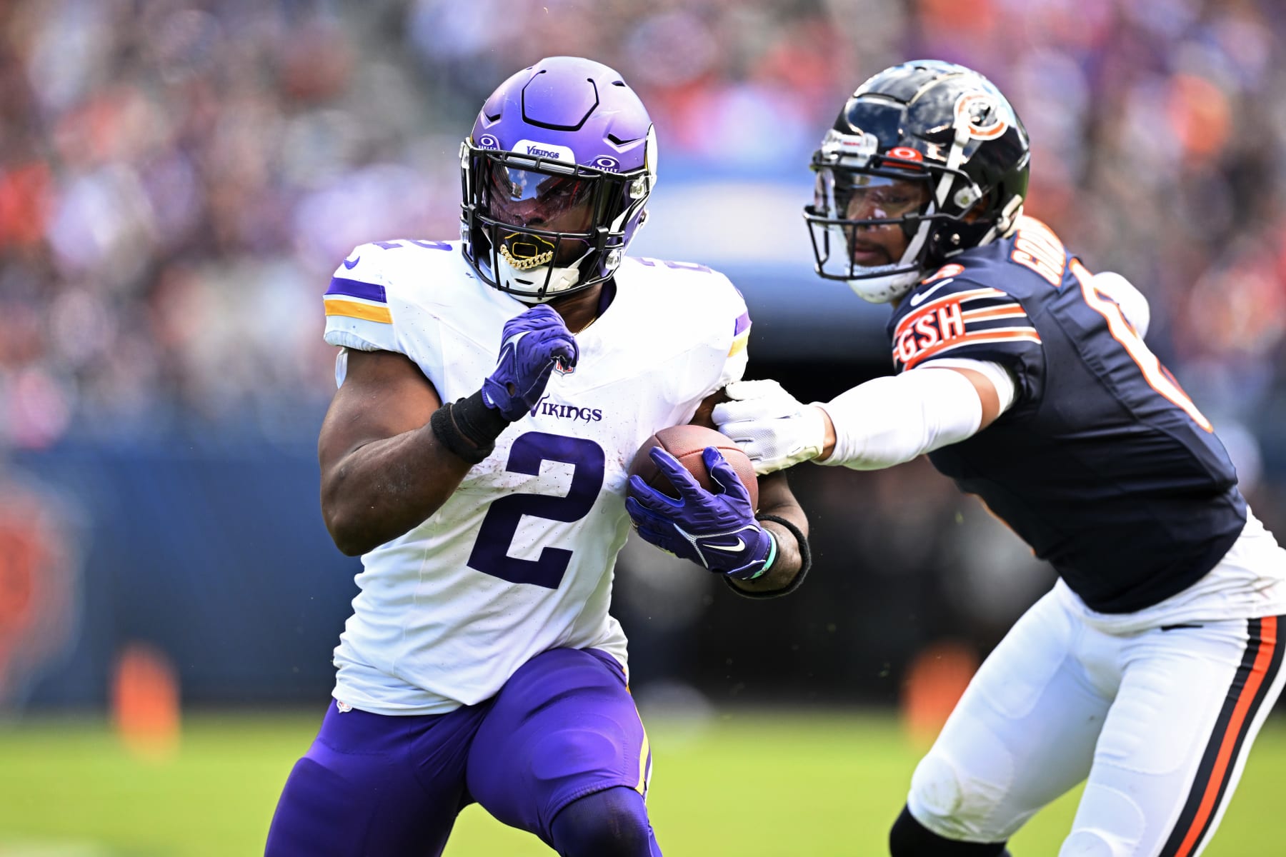 CHICAGO, ILLINOIS - OCTOBER 15: Alexander Mattison #2 of the Minnesota Vikings runs the ball while being chased by Kyler Gordon #6 of the Chicago Bears during the second half at Soldier Field on October 15, 2023 in Chicago, Illinois. (Photo by Quinn Harris/Getty Images)