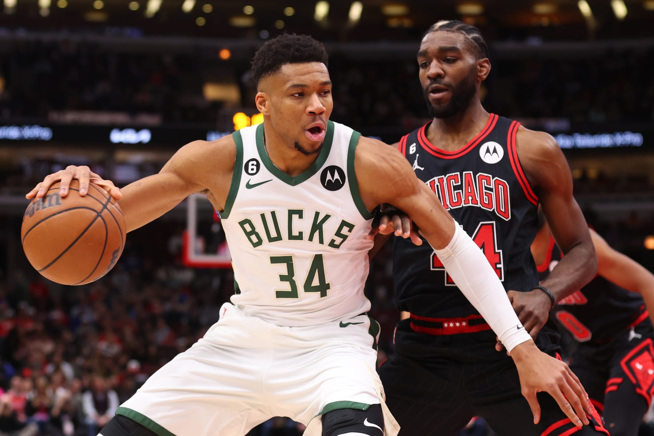 CHICAGO, ILLINOIS - FEBRUARY 16: Giannis Antetokounmpo #34 of the Milwaukee Bucks dribbles against Patrick Williams #44 of the Chicago Bulls during the first half at United Center on February 16, 2023 in Chicago, Illinois. NOTE TO USER: User expressly acknowledges and agrees that, by downloading and or using this photograph, User is consenting to the terms and conditions of the Getty Images License Agreement.  (Photo by Michael Reaves/Getty Images)